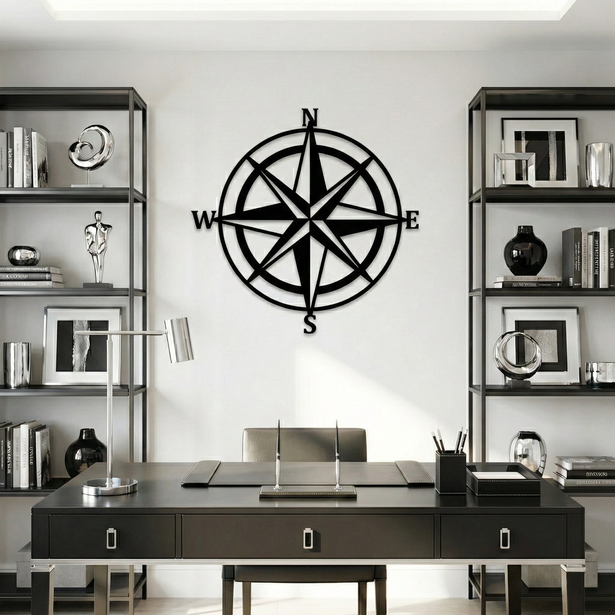 Black compass wall decoration in a modern office setting with bookshelves and a desk.