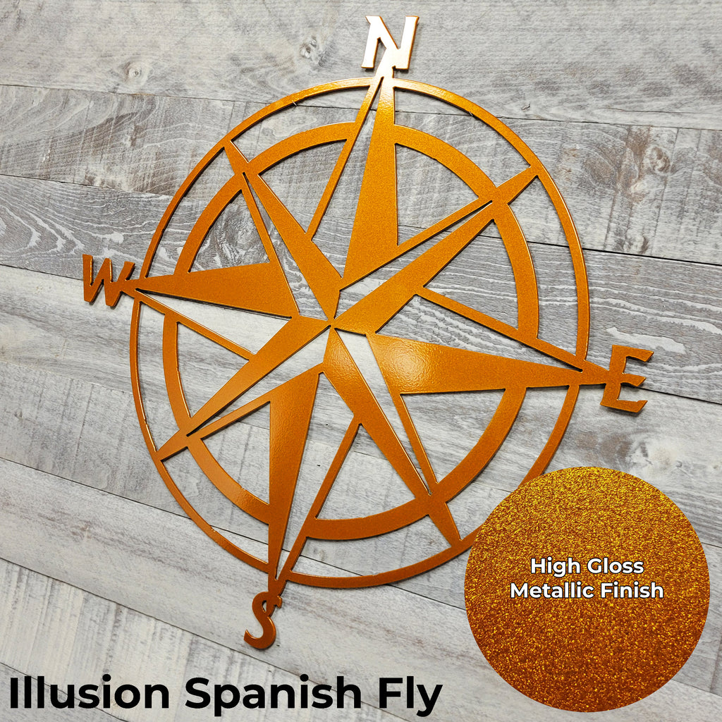 Metallic compass wall art on a wooden surface with 'Illusion Spanish Fly' text.