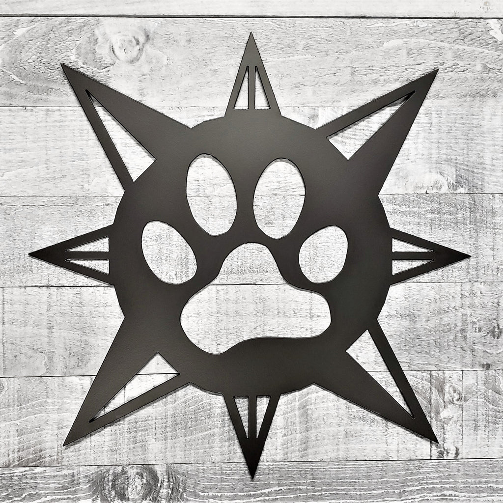 black compass rose with dog paw in center on a wooden background