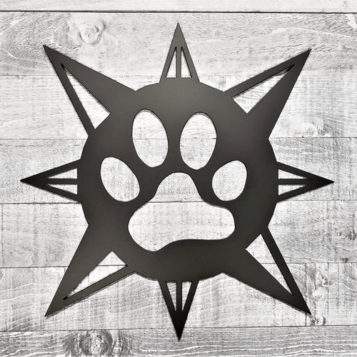 black compass rose with dog paw in center on a wooden background