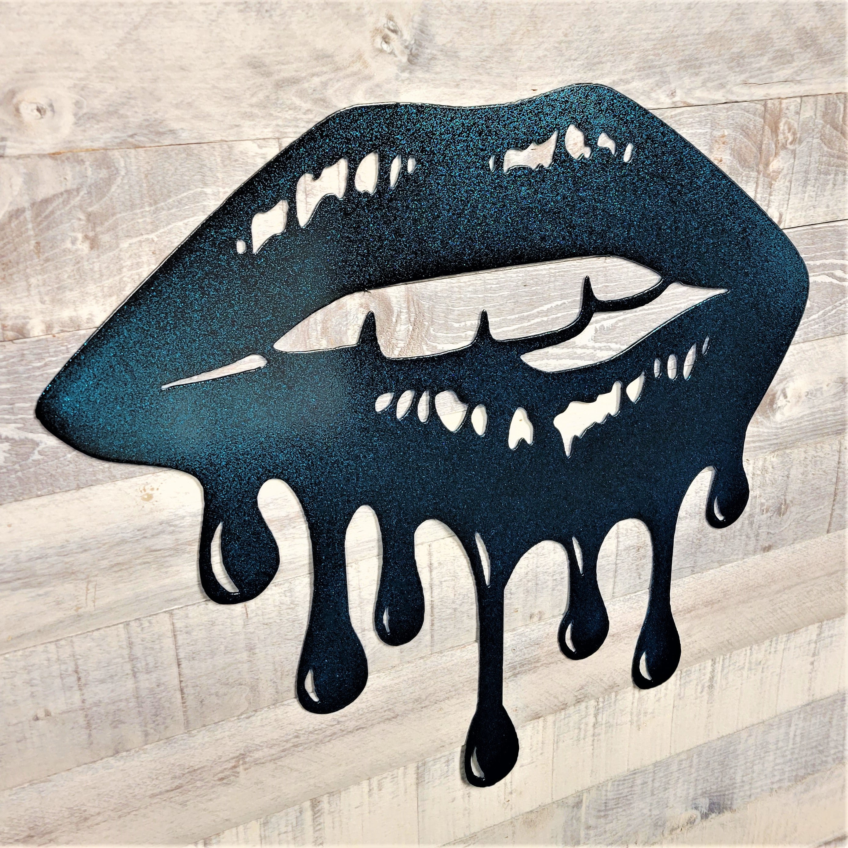 Metallic blue lips with dripping effect on a wooden background