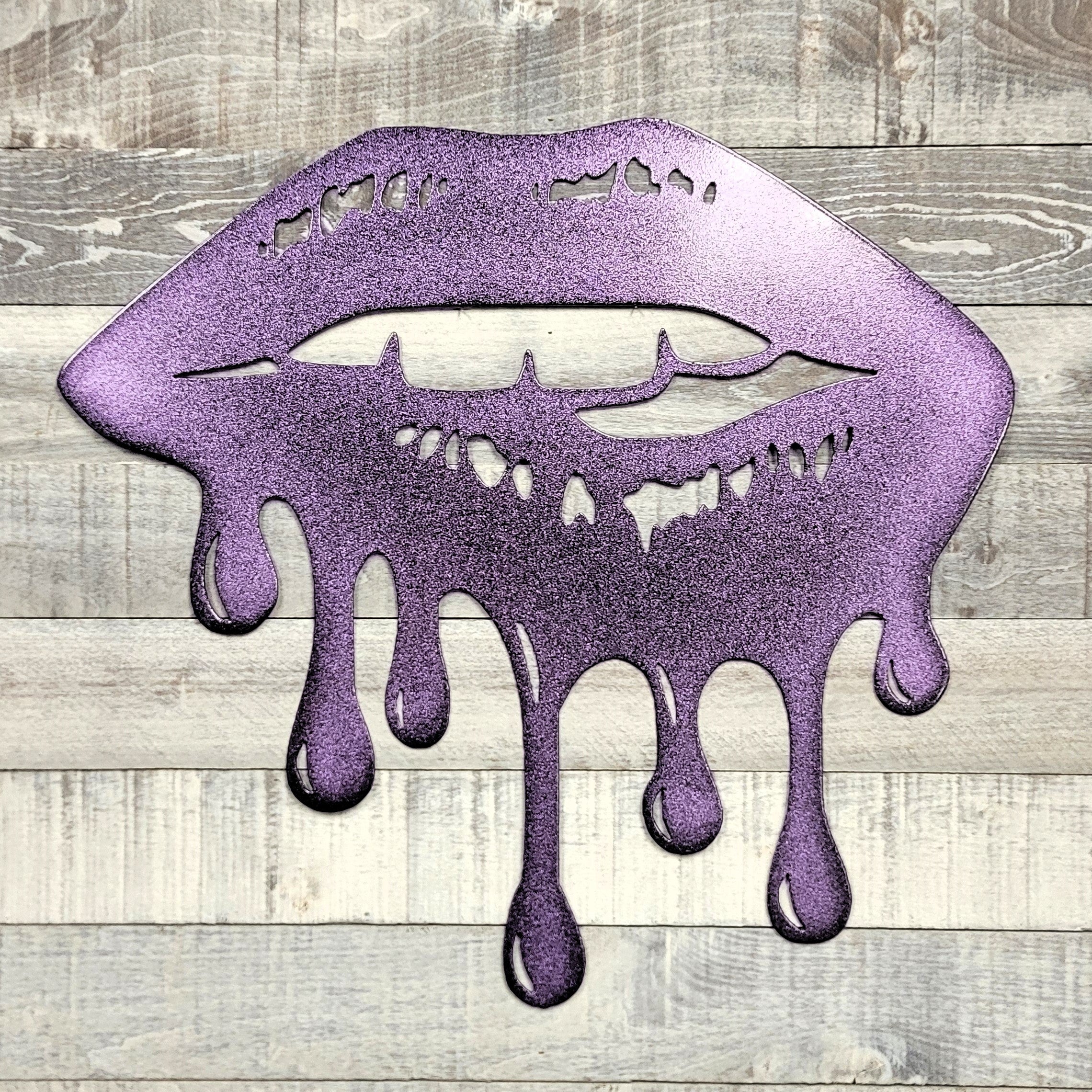 Metallic purple lips with dripping effect on a wooden background