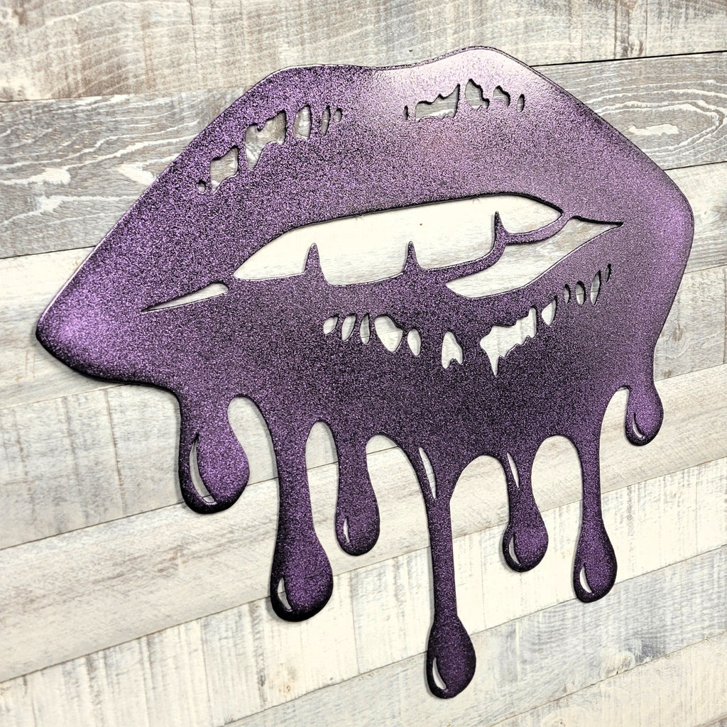 Metallic purple lips with a dripping effect on a wooden surface