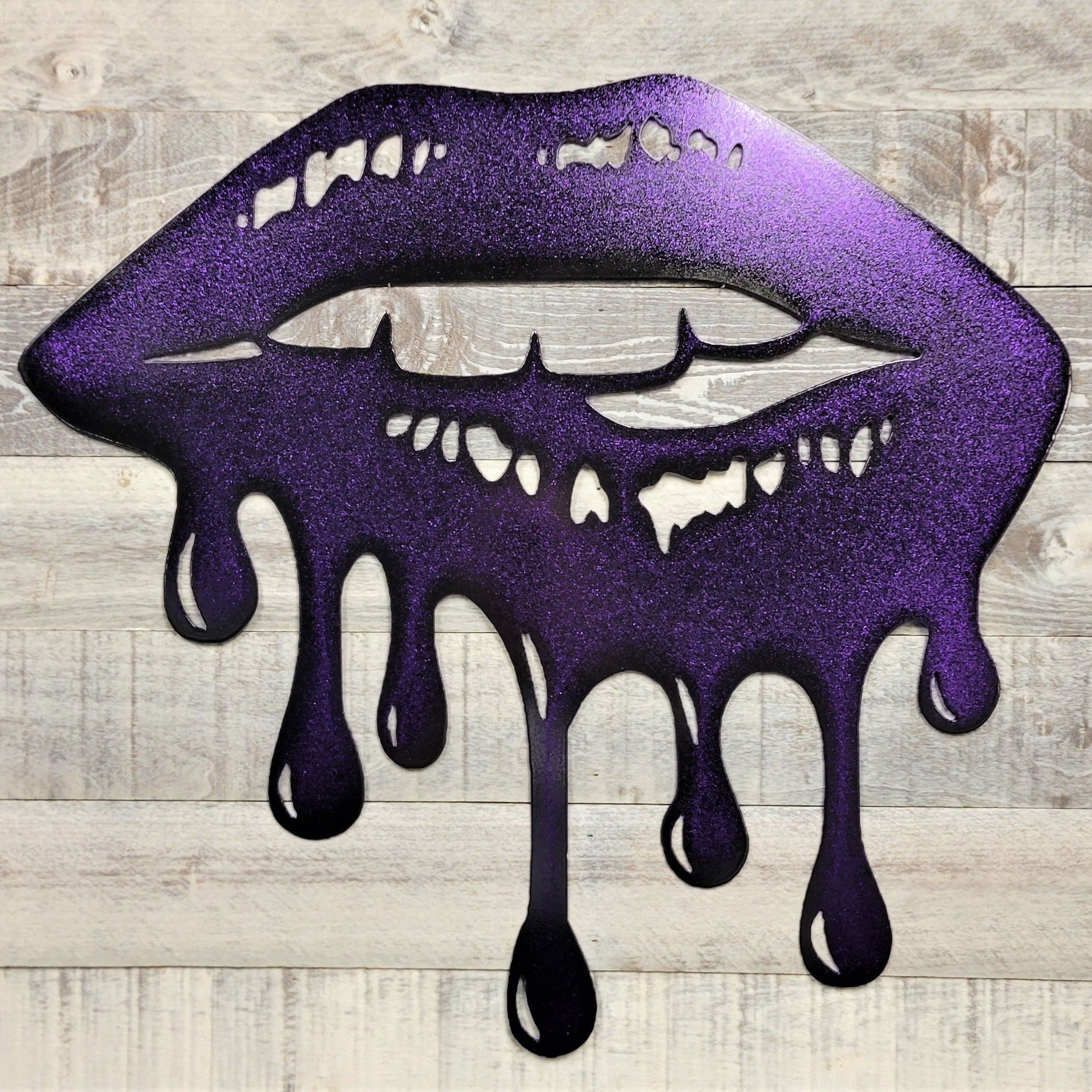 Metallic purple lips with dripping effect on a wooden background