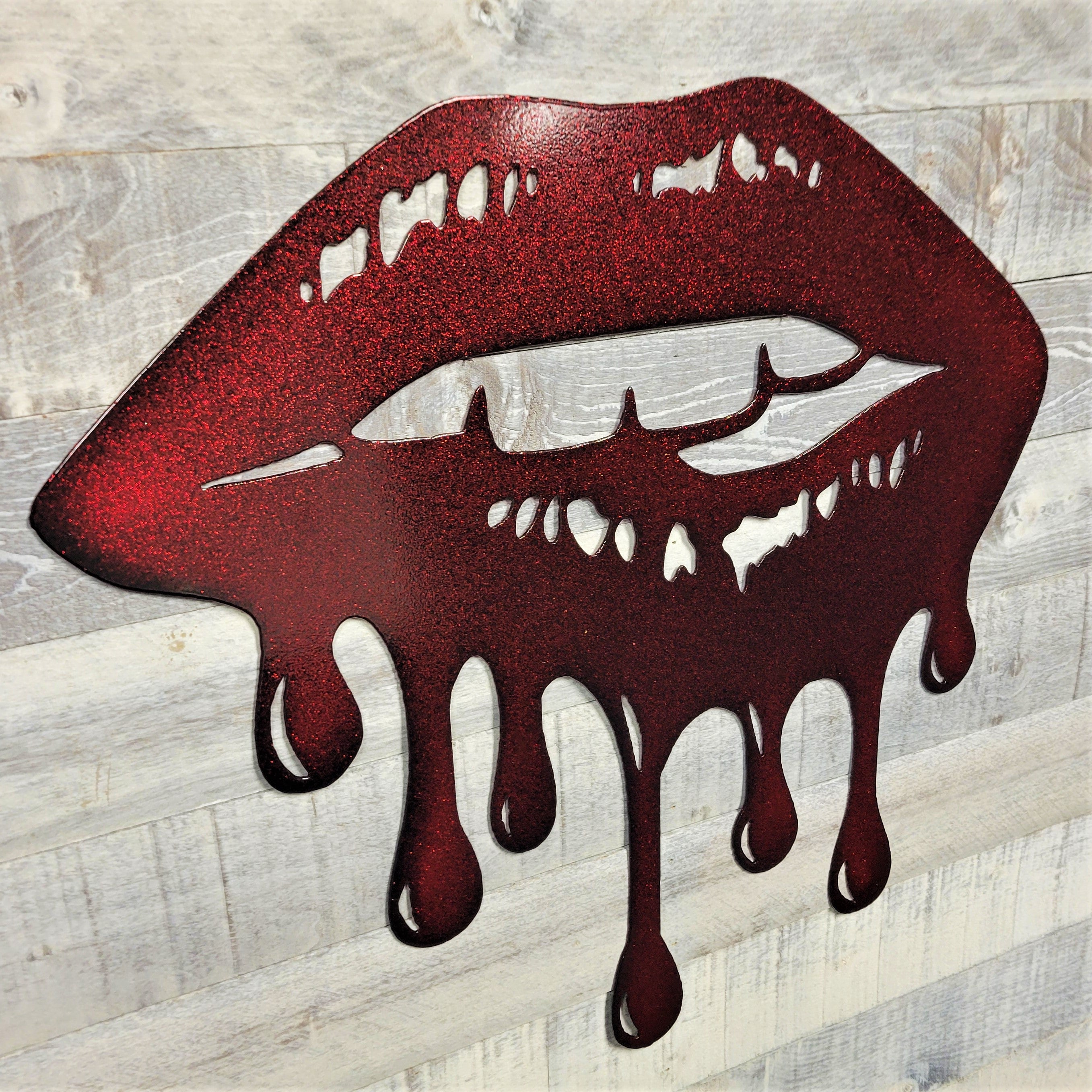 Metallic red lips with dripping effect on a wooden background