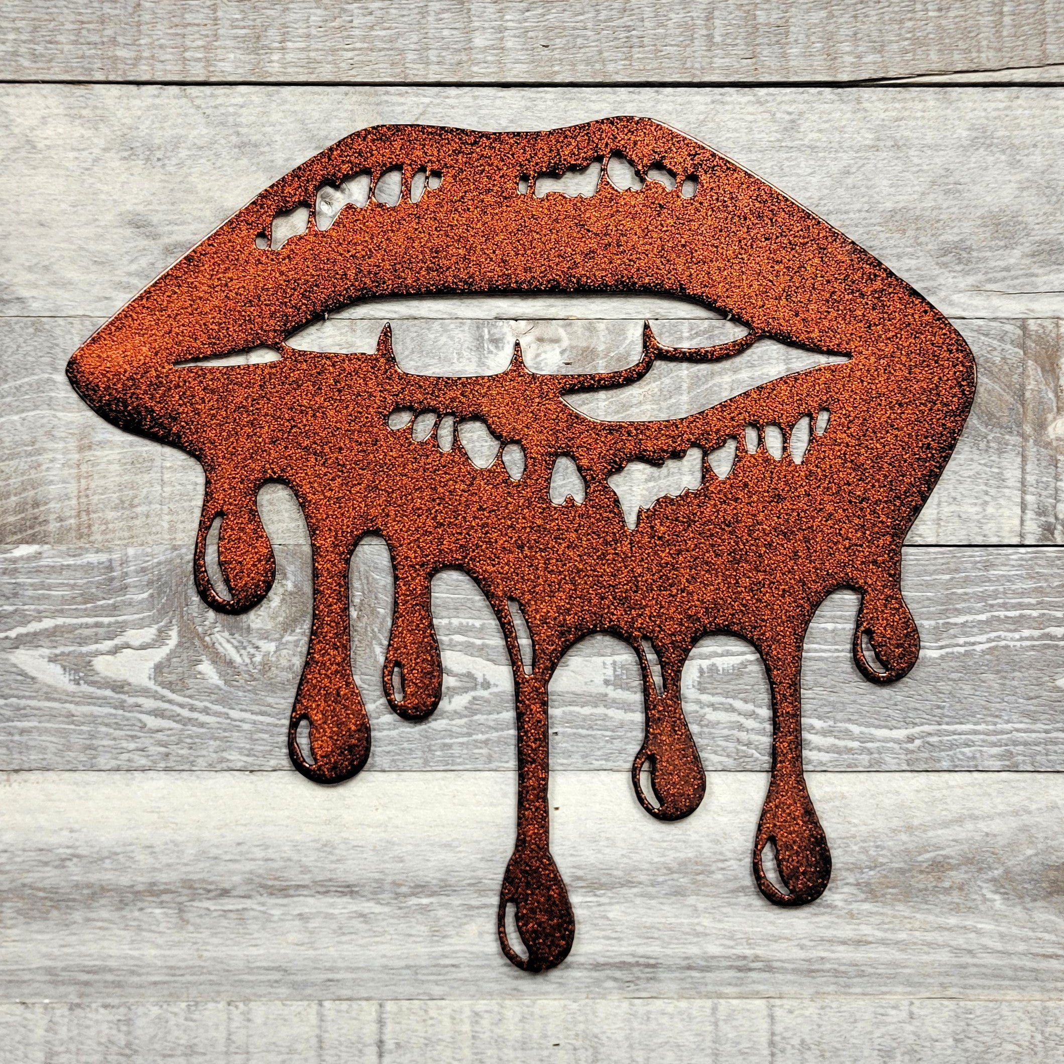 Metallic lips with dripping effect on a wooden background