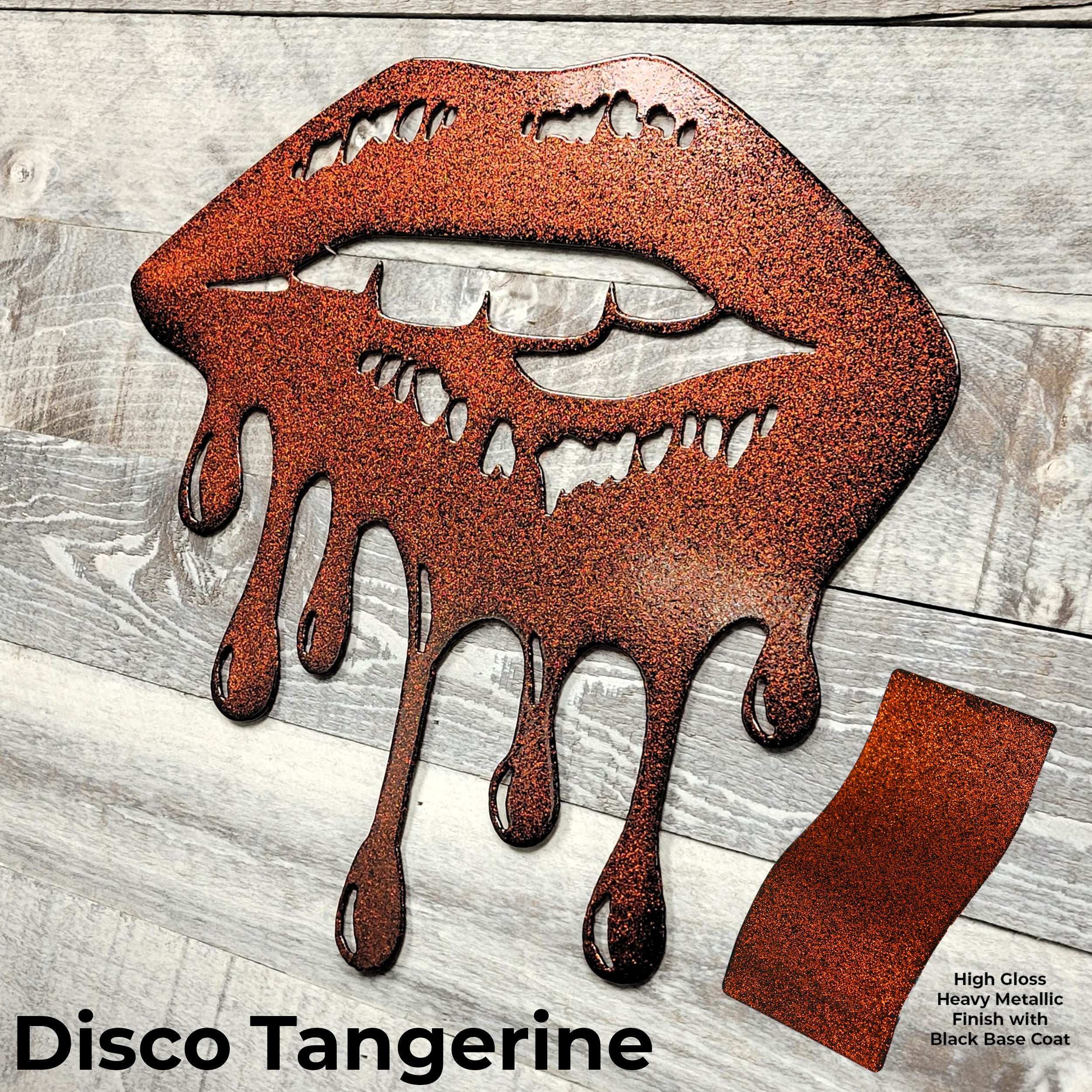 Metallic lips sculpture with a glossy finish on a wooden surface, labeled 'Disco Tangerine'.