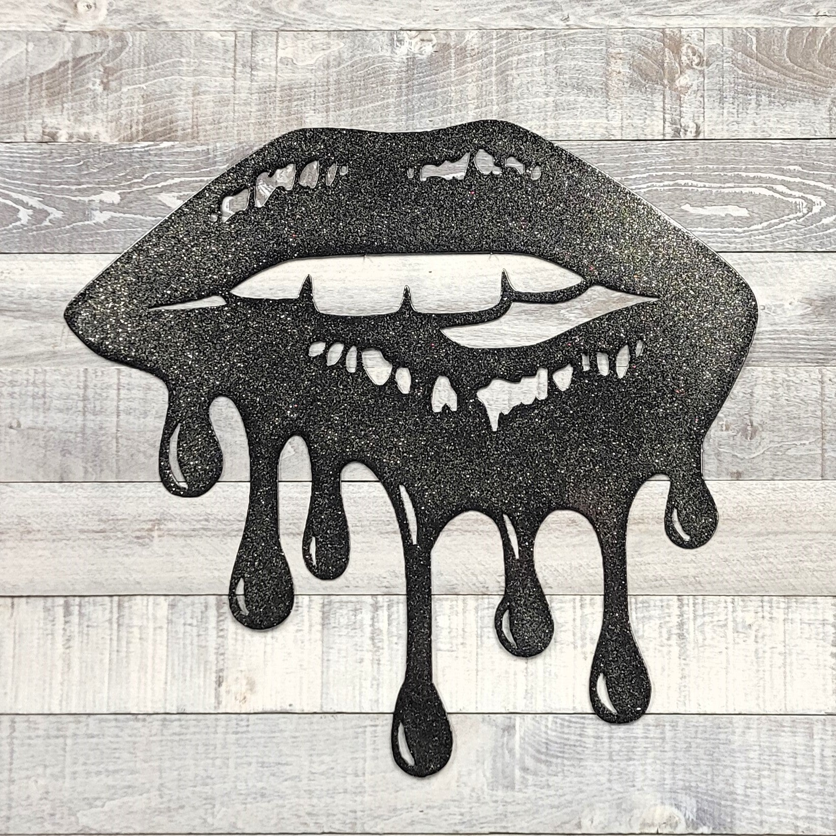 Black lips with dripping effect on a wooden background
