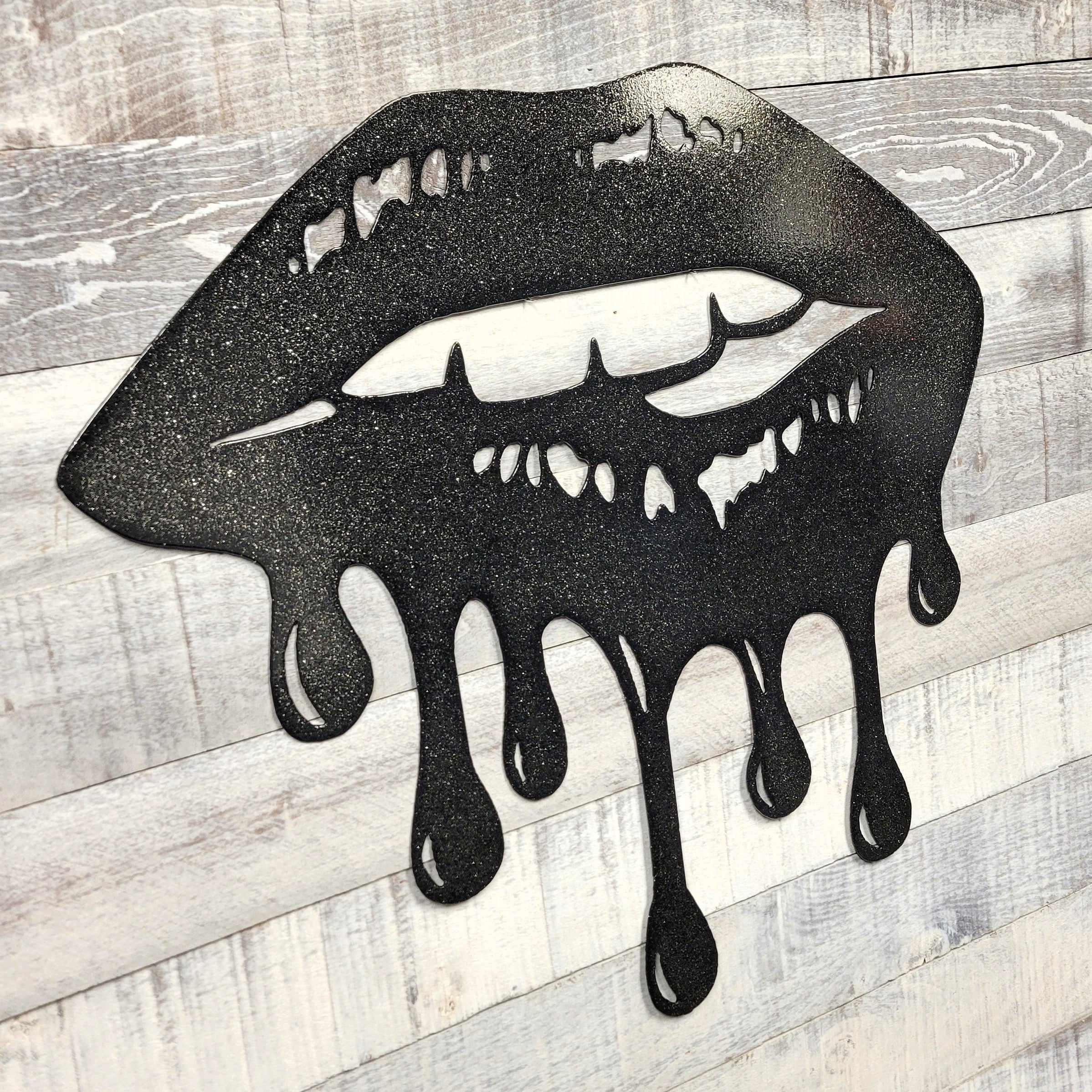 Black lips with dripping effect on a wooden background