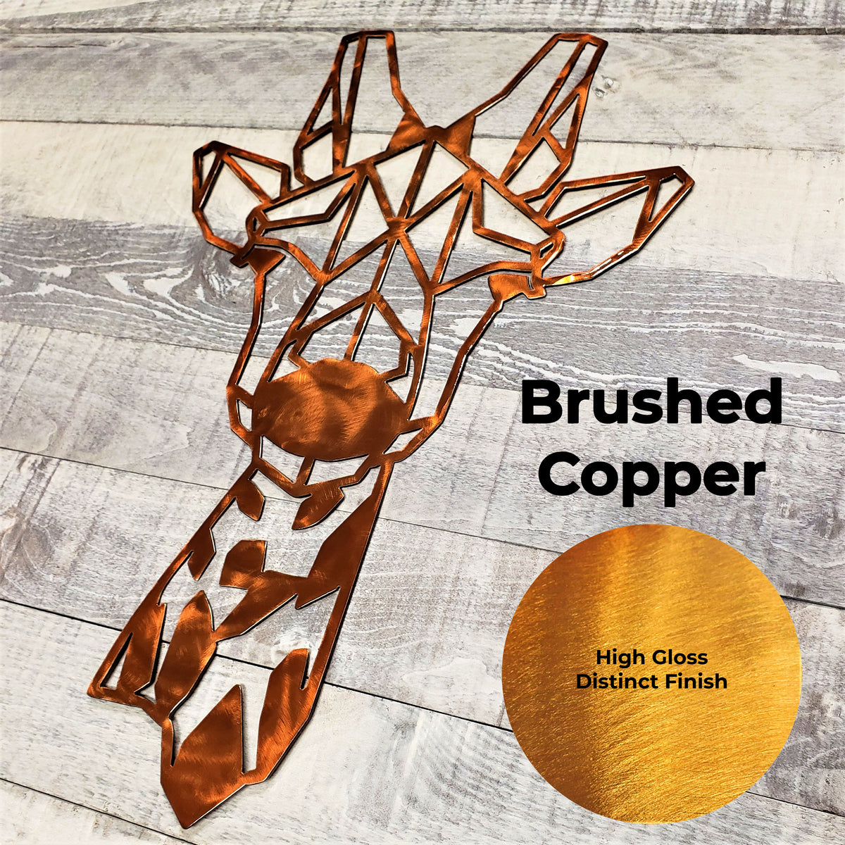 Metal wall art of a giraffe head in brushed copper on a wooden surface with a color swatch.