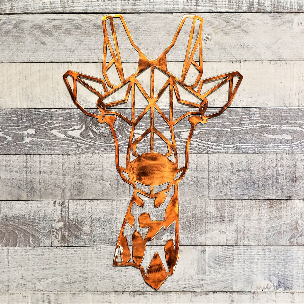 Geometric metal giraffe head wall art on a wooden background