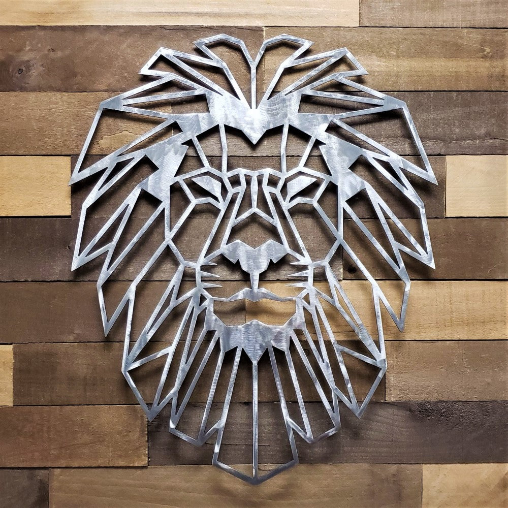 Metal lion head wall art on a wooden panel background