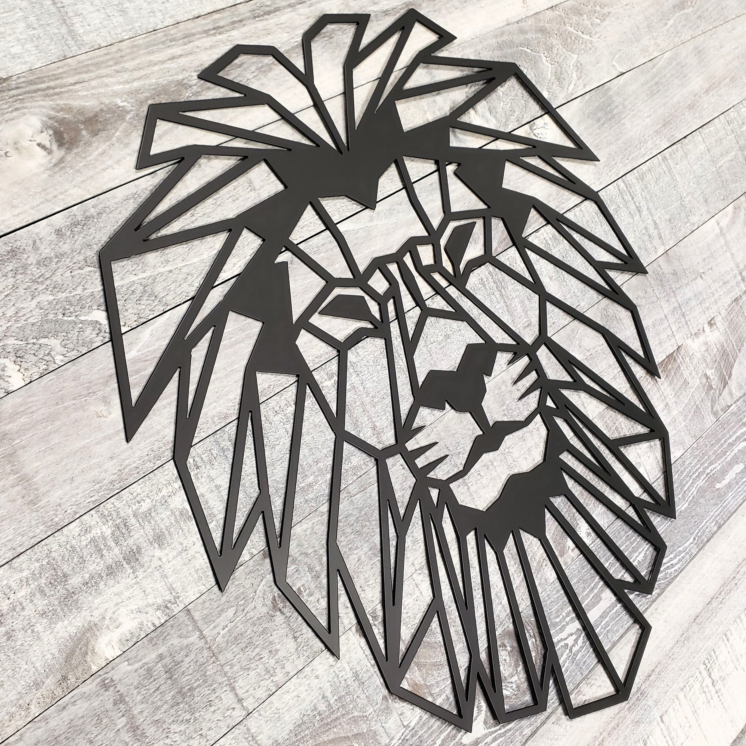 black geometric lion wall art on a wooden floor