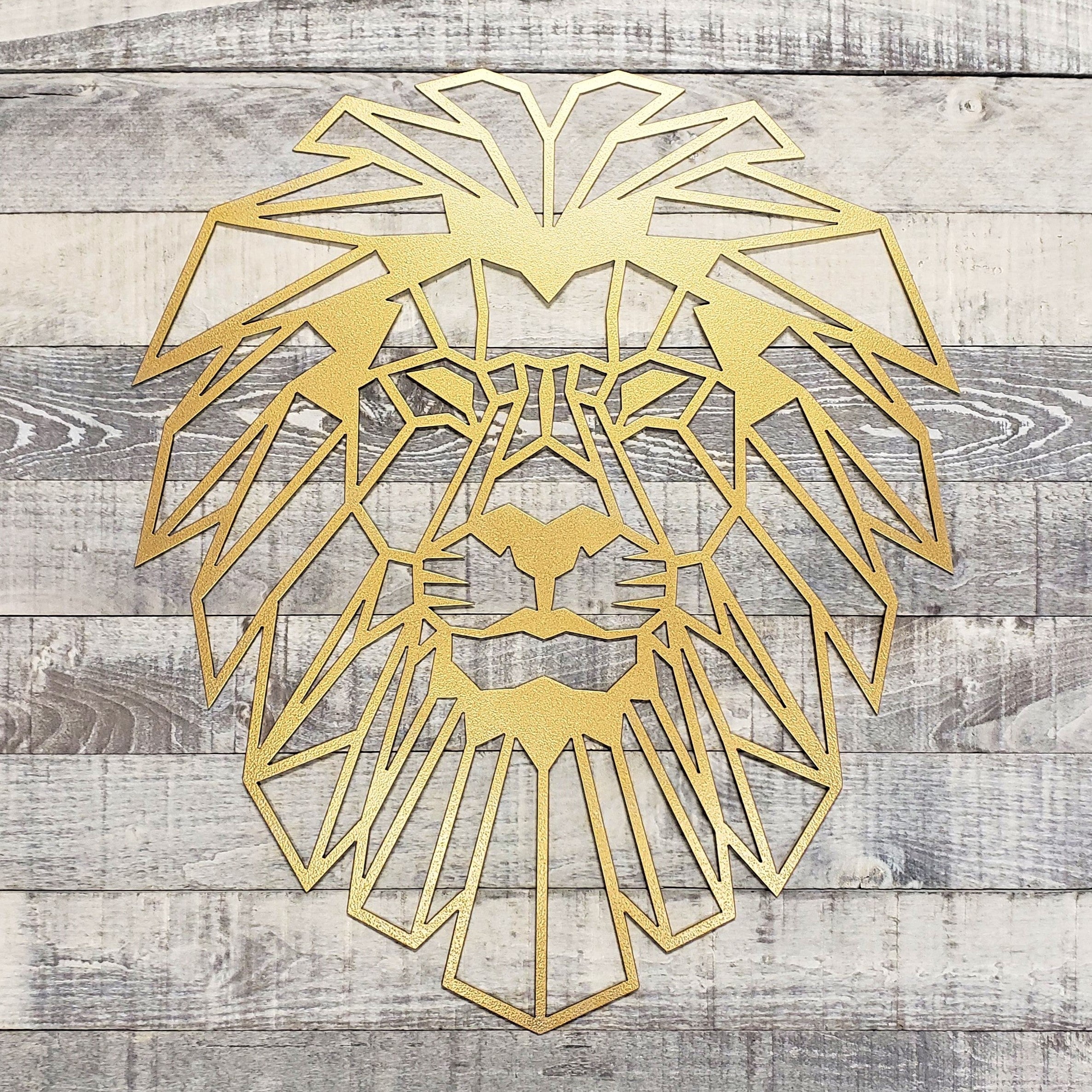 Gold geometric lion head wall art on a wooden background