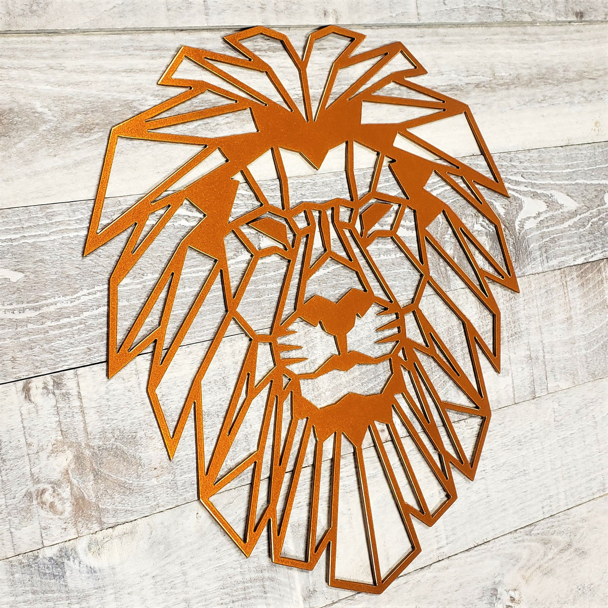 Geometric lion head wall art on a wooden surface