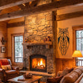 Cozy living room with stone fireplace, wooden beams, and a wall-mounted geometric owl art piece.