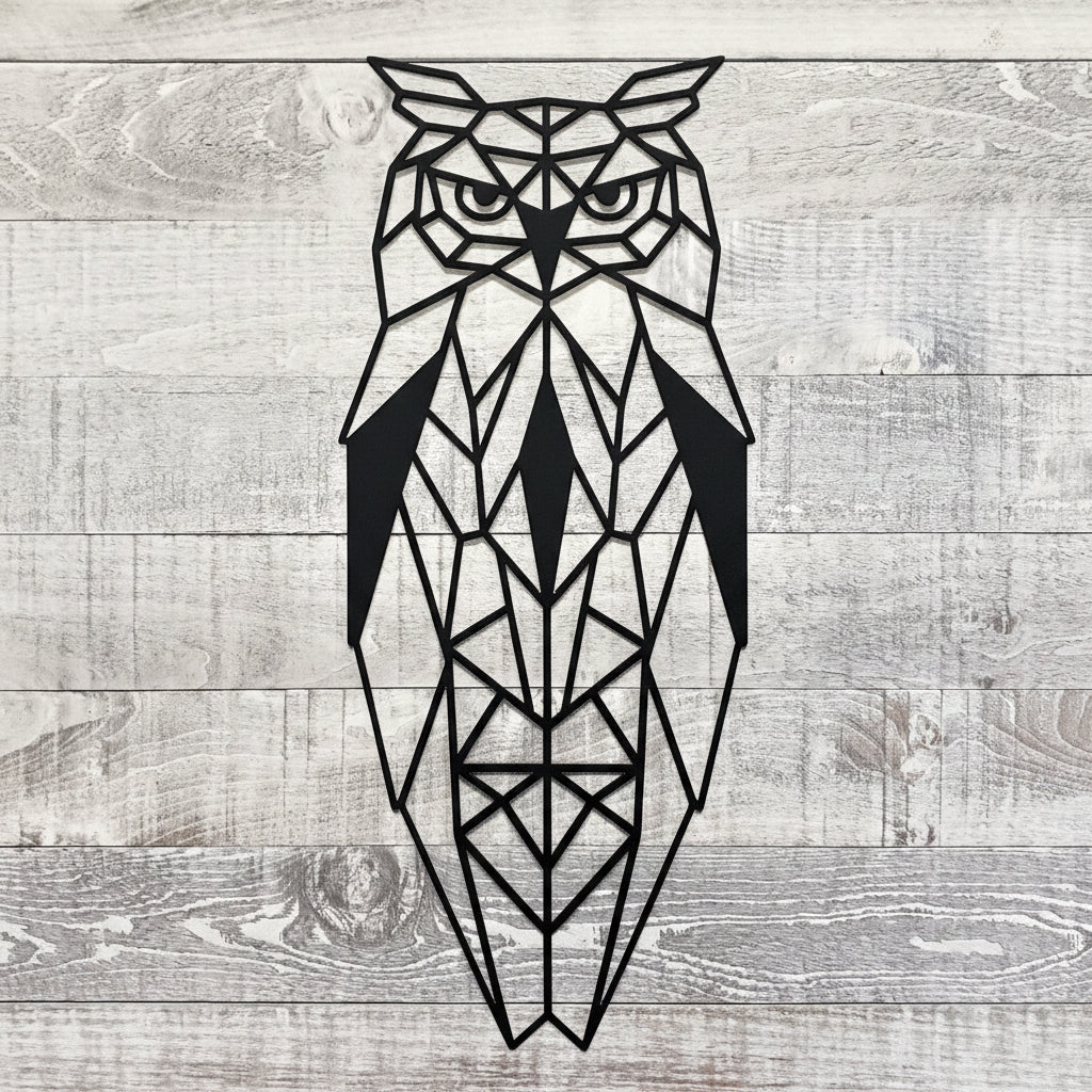 Black geometric owl metal wall art on a wooden background