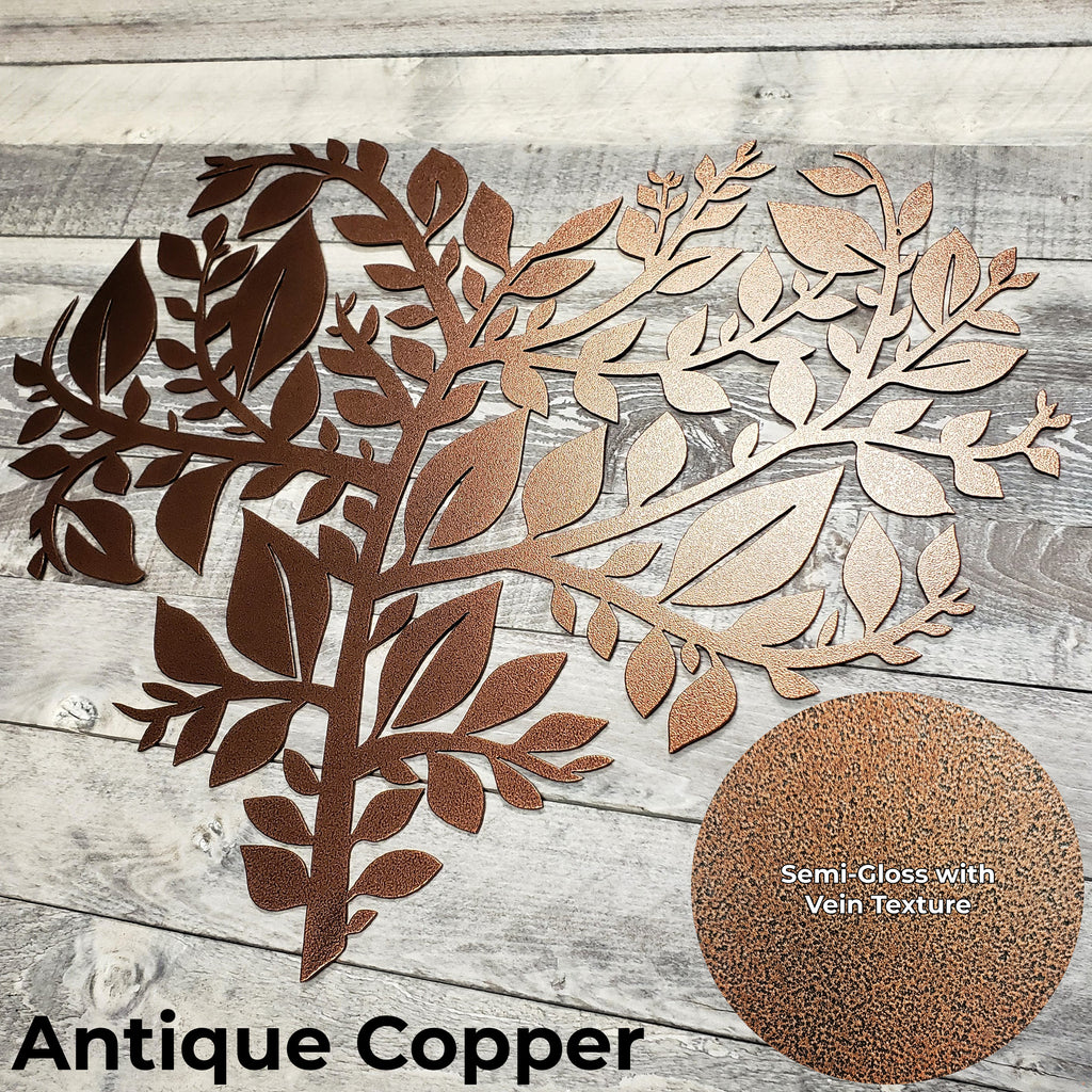 Decorative leaf patterns in antique copper on a wooden surface with a close-up of the material texture.