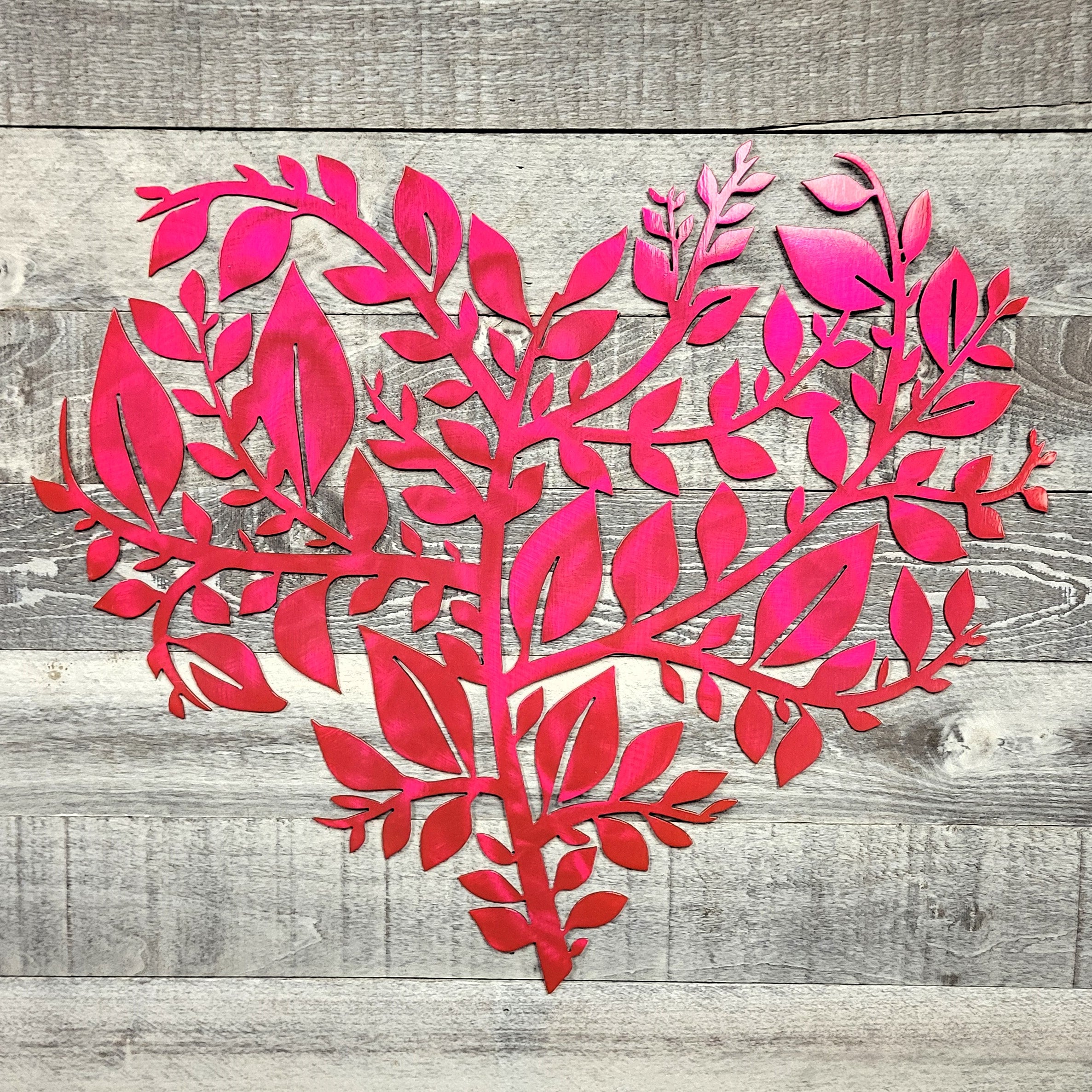 pink leaf-shaped cutout on a wooden background