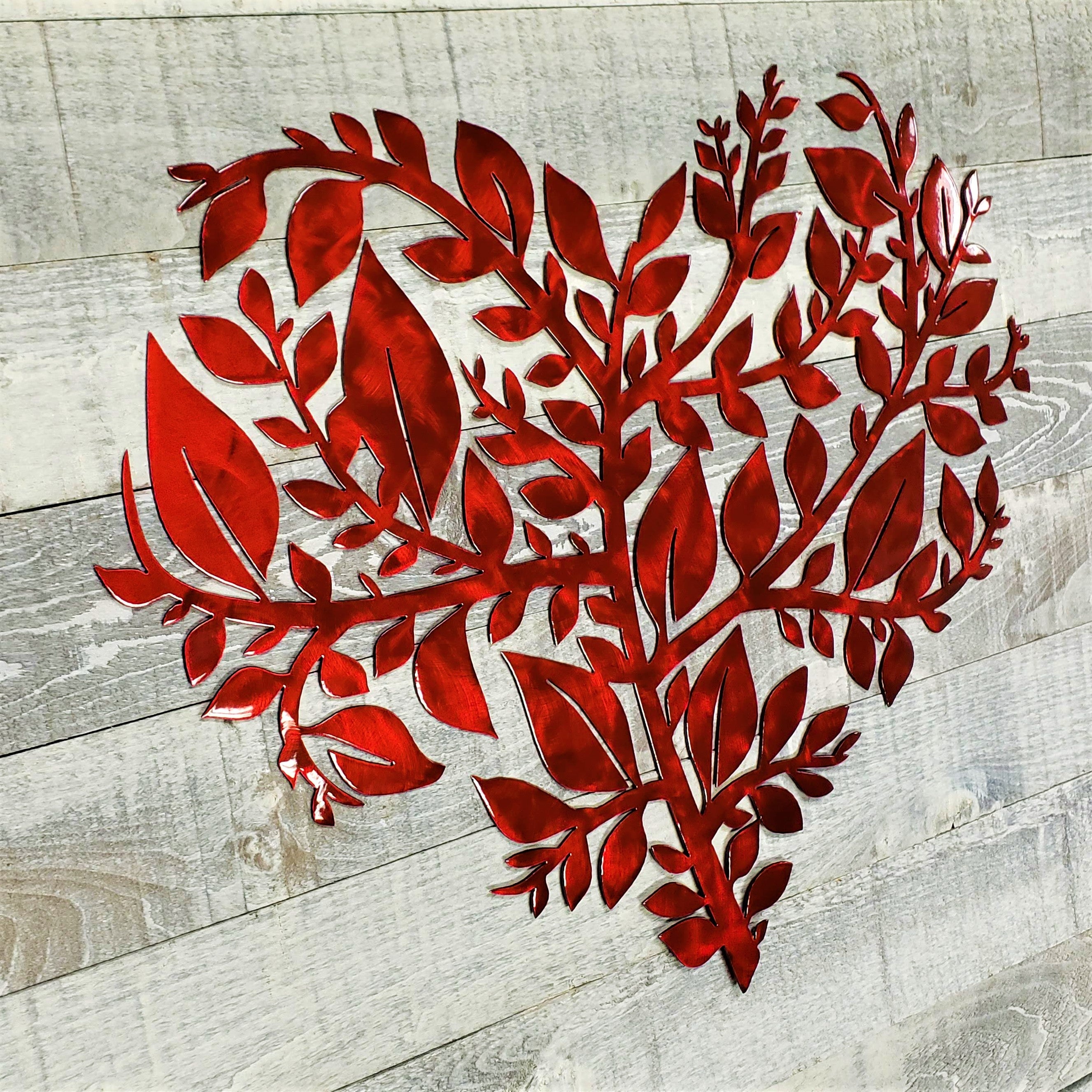 Red metal leaf design on a wooden surface