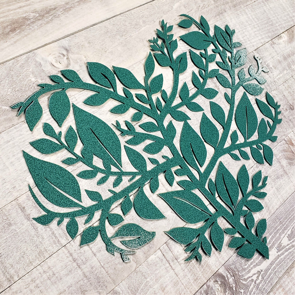 Decorative metal leaf design on a wooden floor