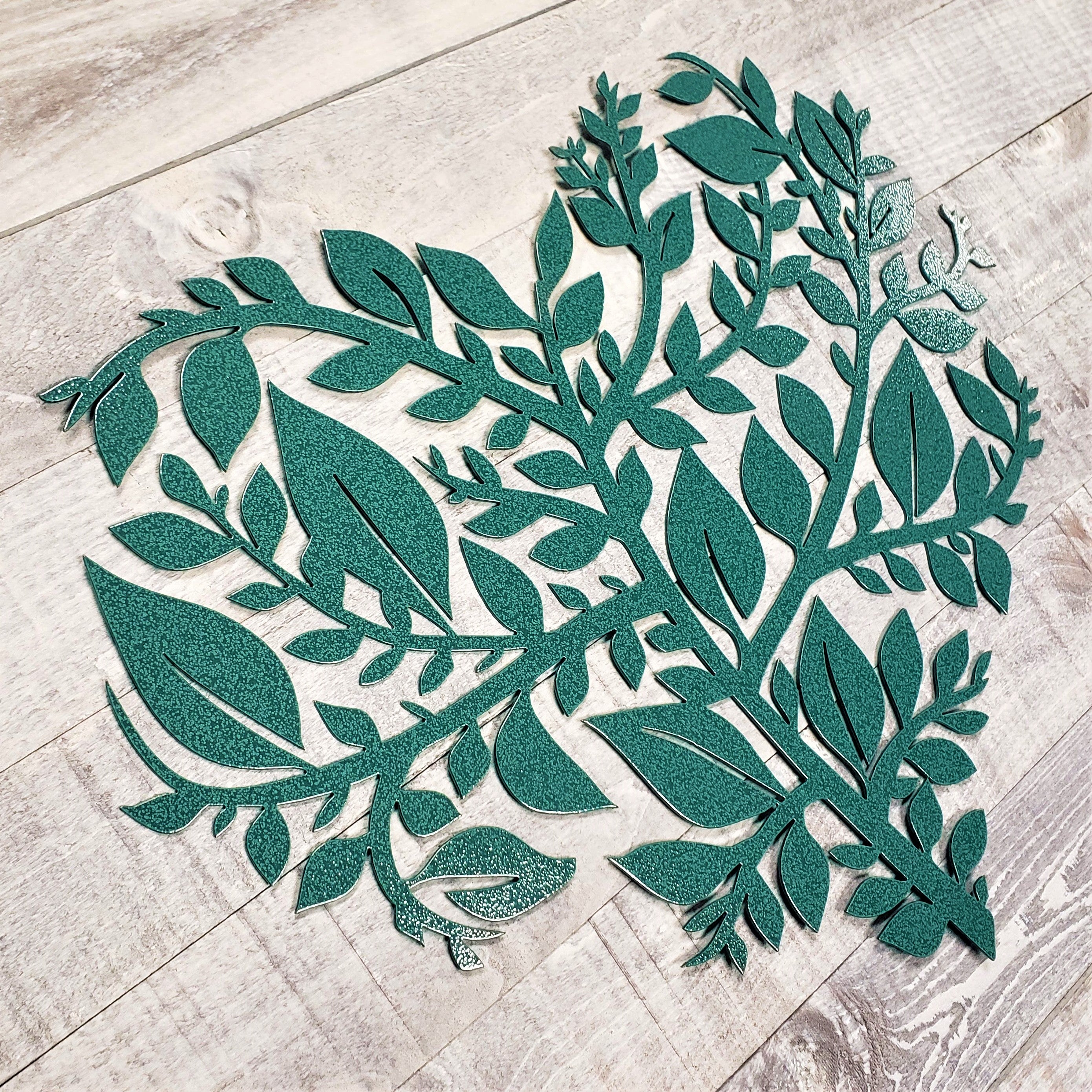 Decorative metal leaf design on a wooden floor