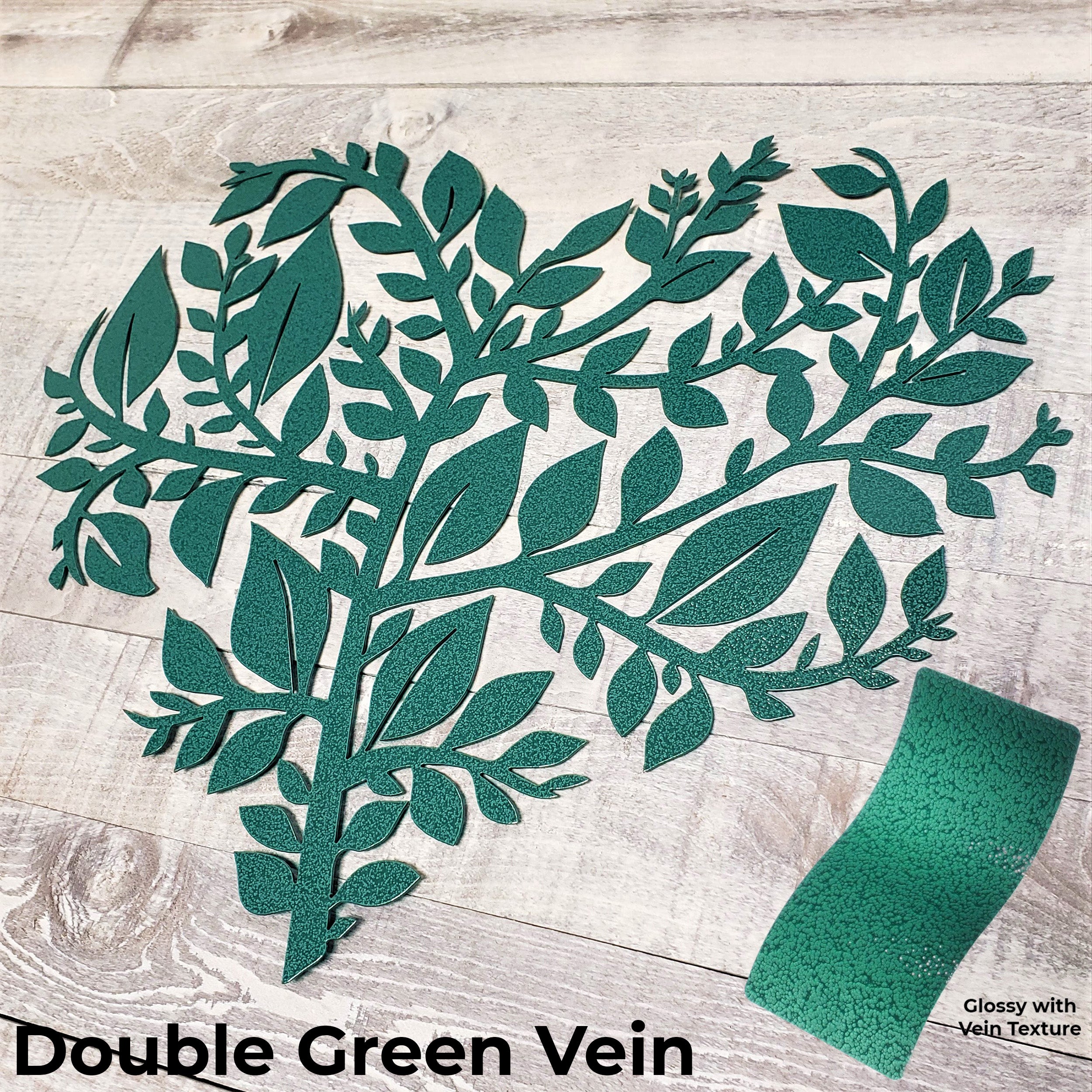 green leaf pattern with a green paint swatch on a wooden surface, labeled 'Double Green Vein'.