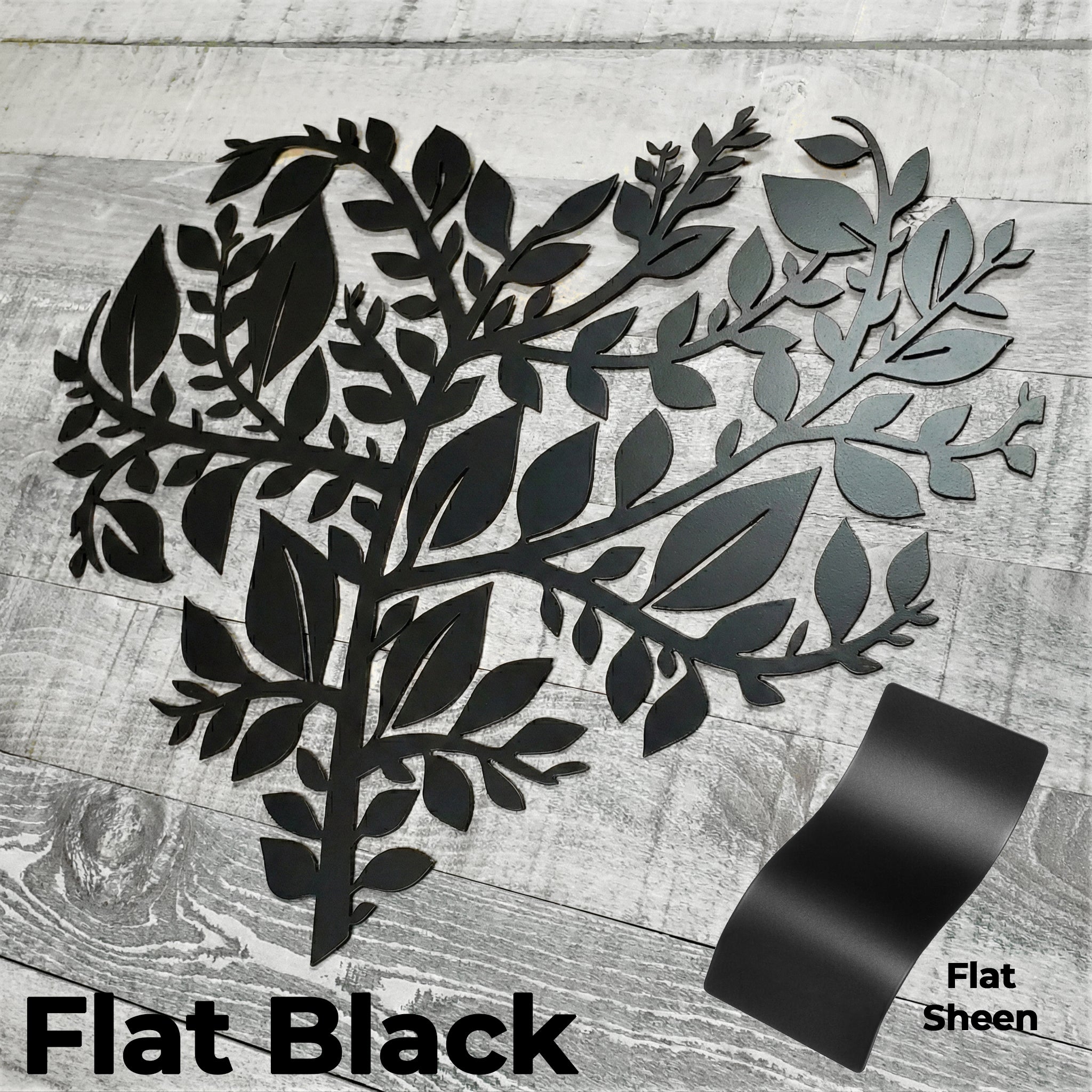 Decorative metal wall art with leaf design on a wooden surface, featuring flat black color swatch.