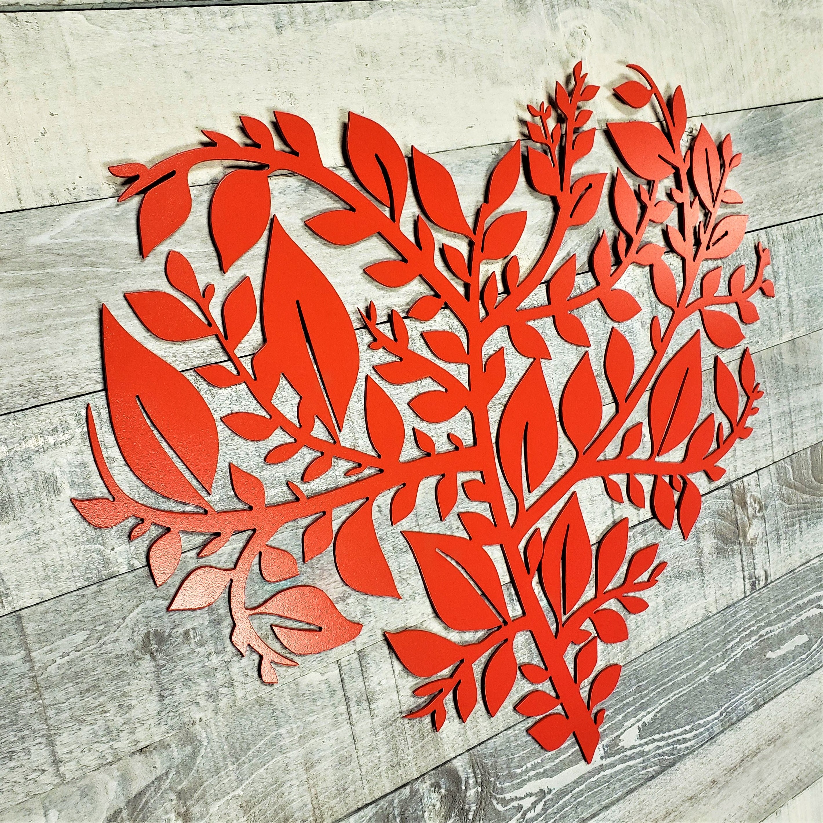Red floral cutout on a wooden surface