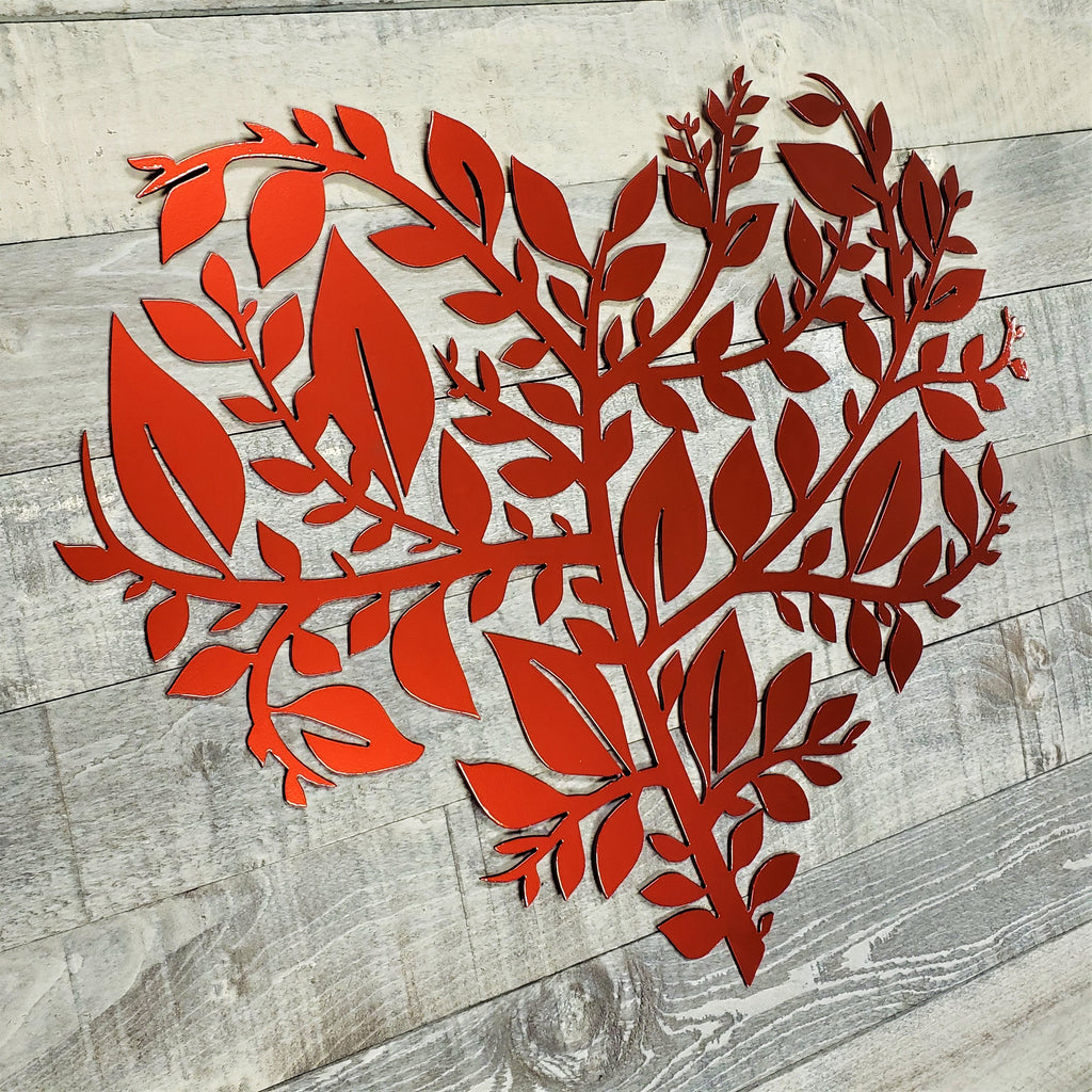 Red leaf-shaped cutout on a wooden surface