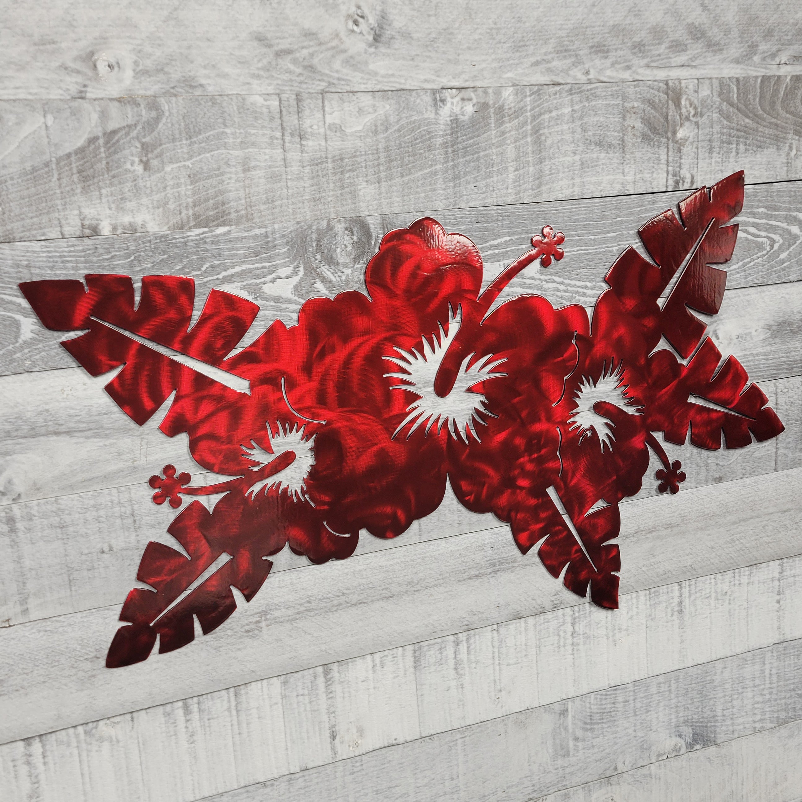 Red floral design on a wooden surface
