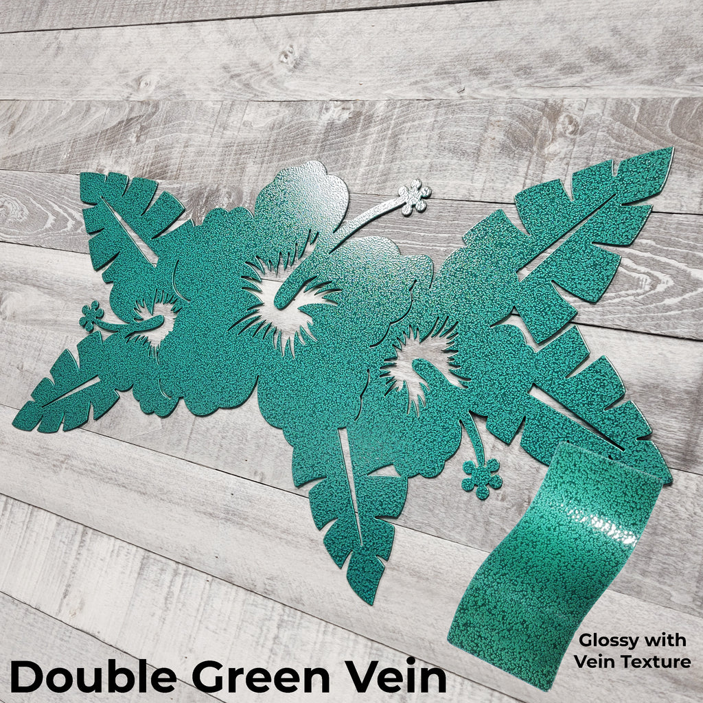 green floral metal wall art on a wooden surface