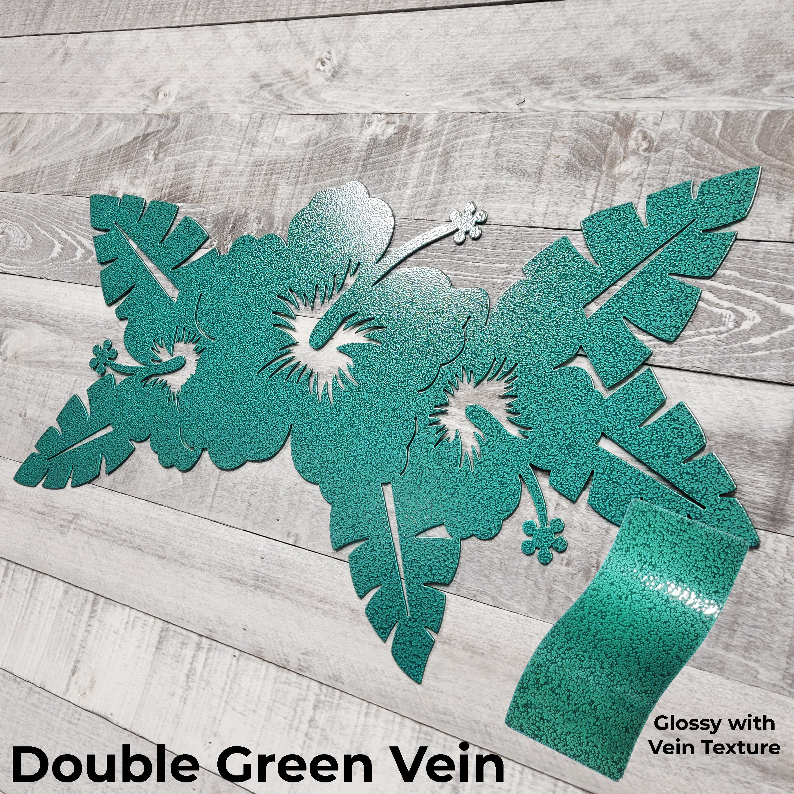 green floral metal wall art on a wooden surface