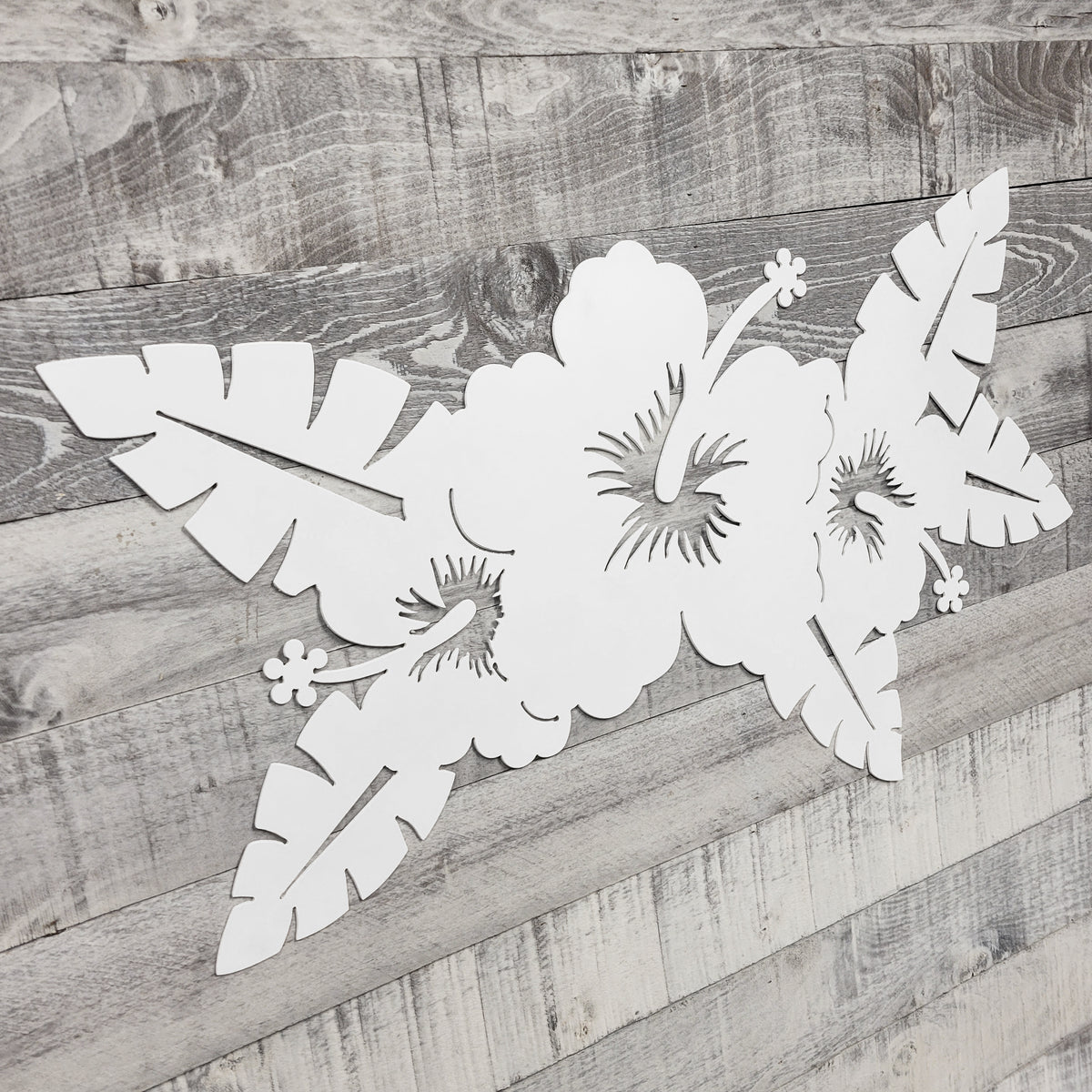 White floral cutout on a wooden surface