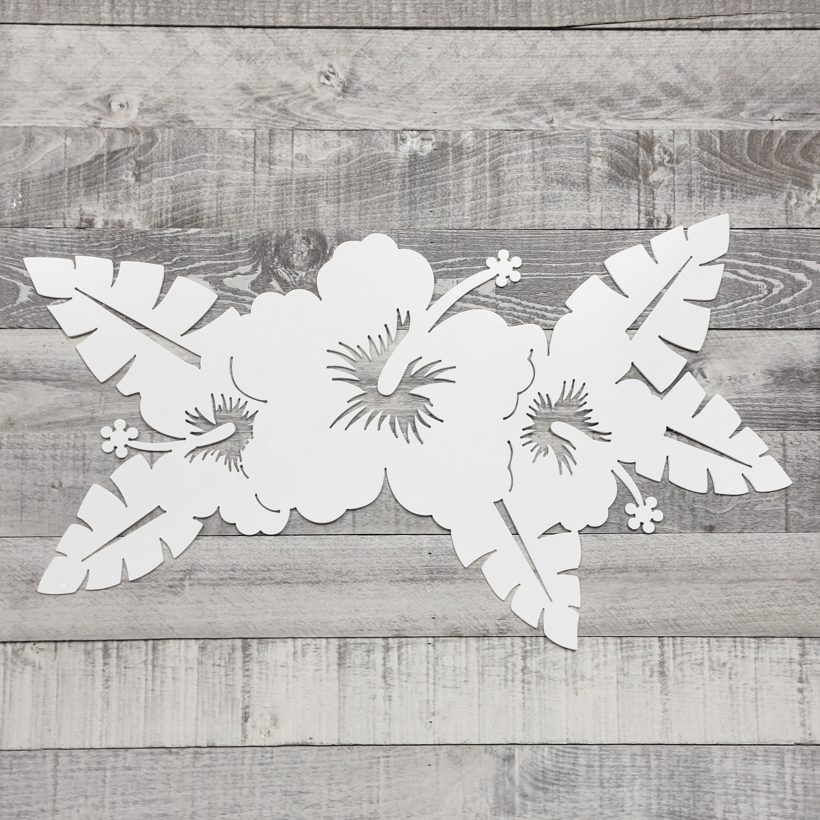 White floral cutout on a wooden background