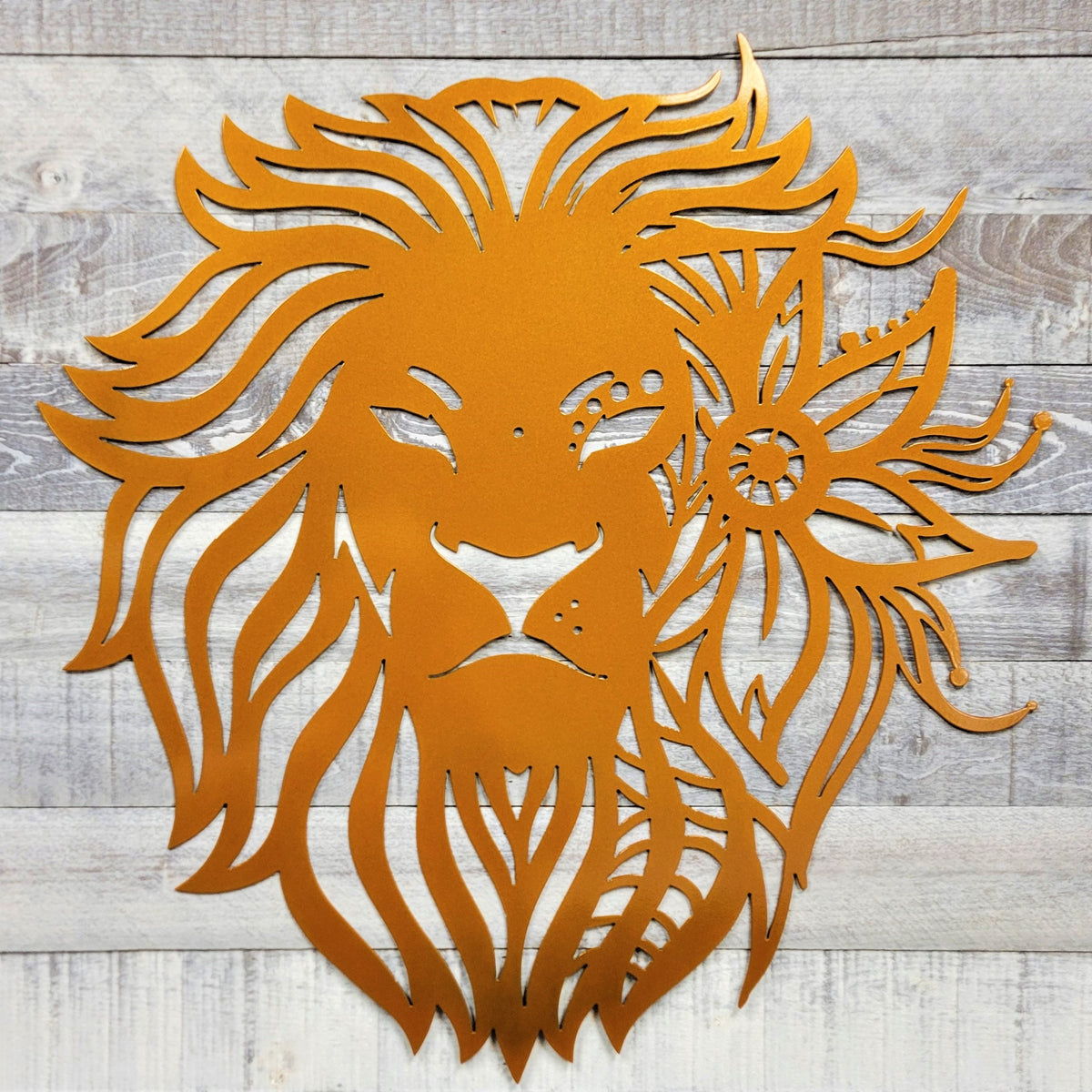 Metallic lion head design on a wooden background