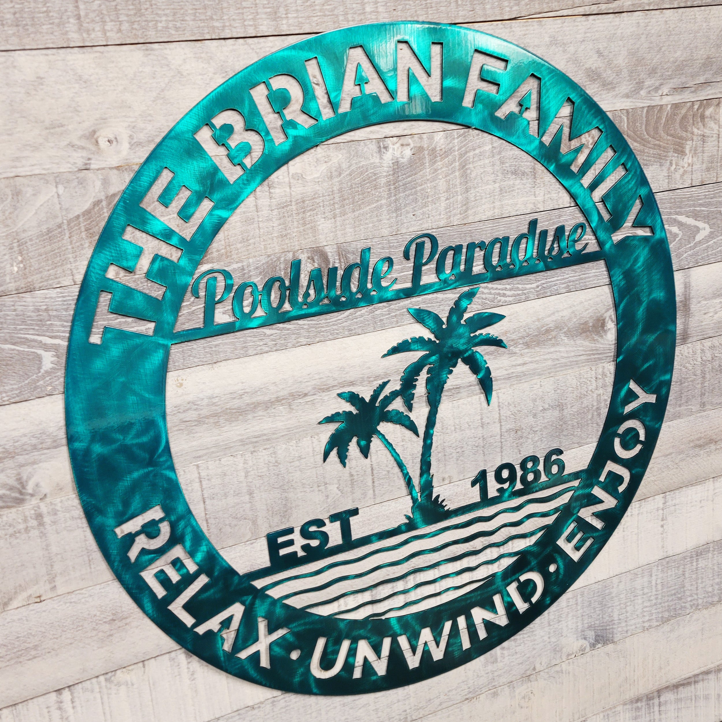 Decorative metal sign for a pool patio on a wooden background