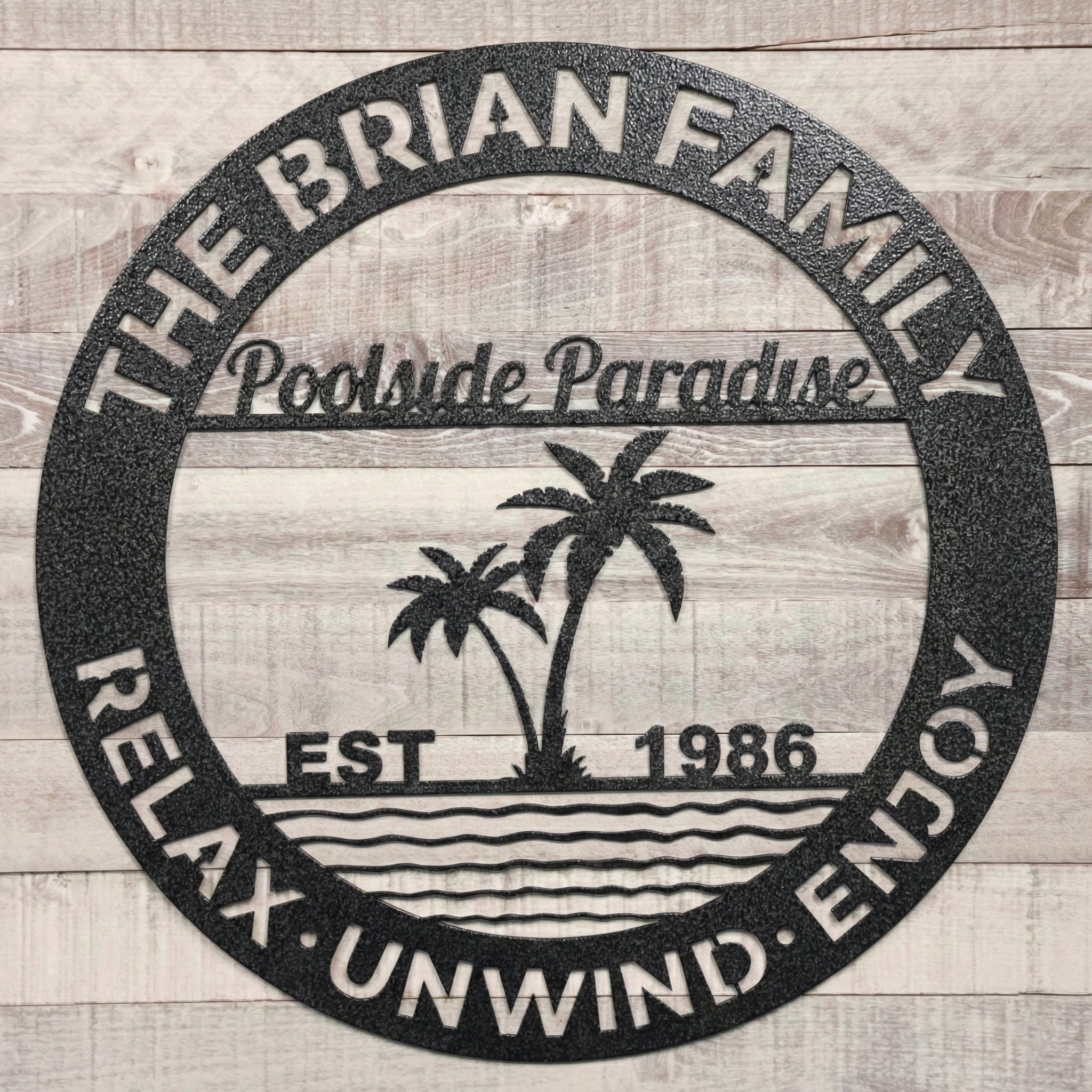Black Decorative metal sign, poolside paradise art on a wooden background