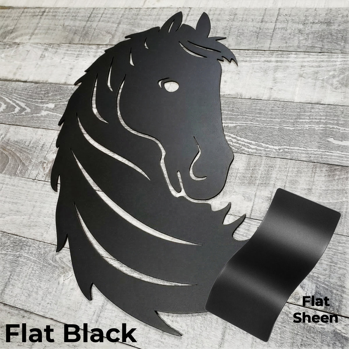 Black metal horse head wall art on a wooden surface with color panel