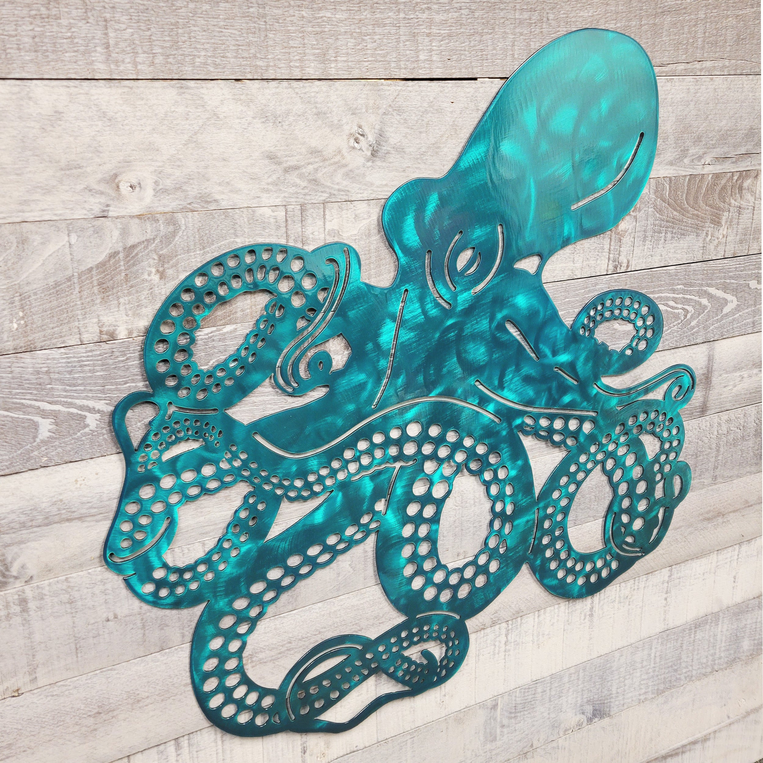 Metal octopus wall art on a wooden surface