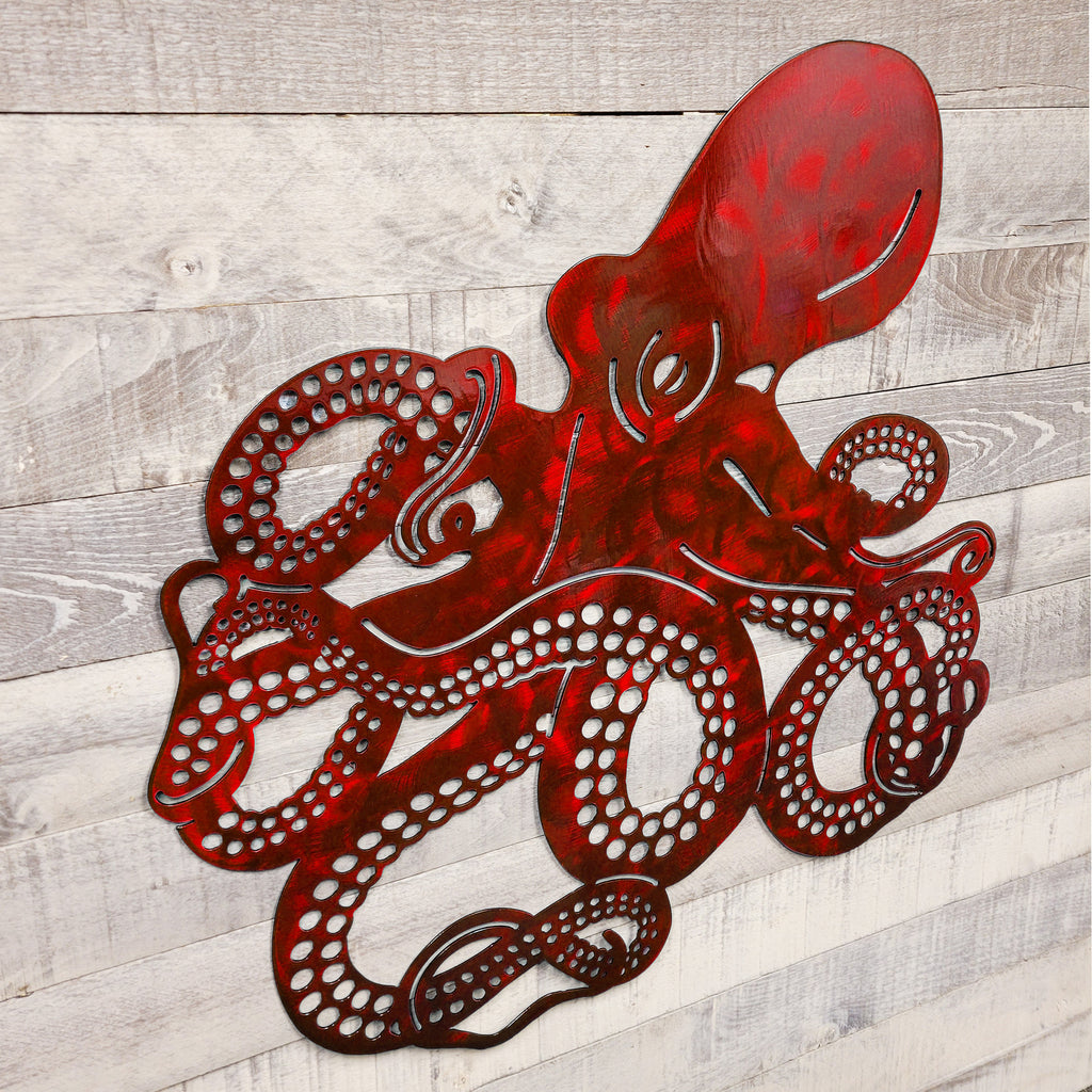 Red metal octopus wall art on a wooden background