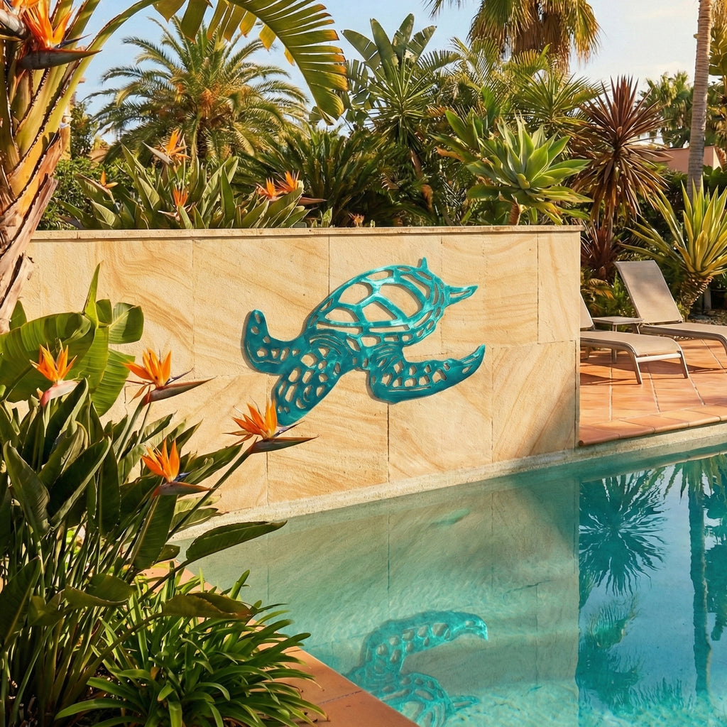 Decorative turtle sculpture on a stone wall by a pool with tropical plants.