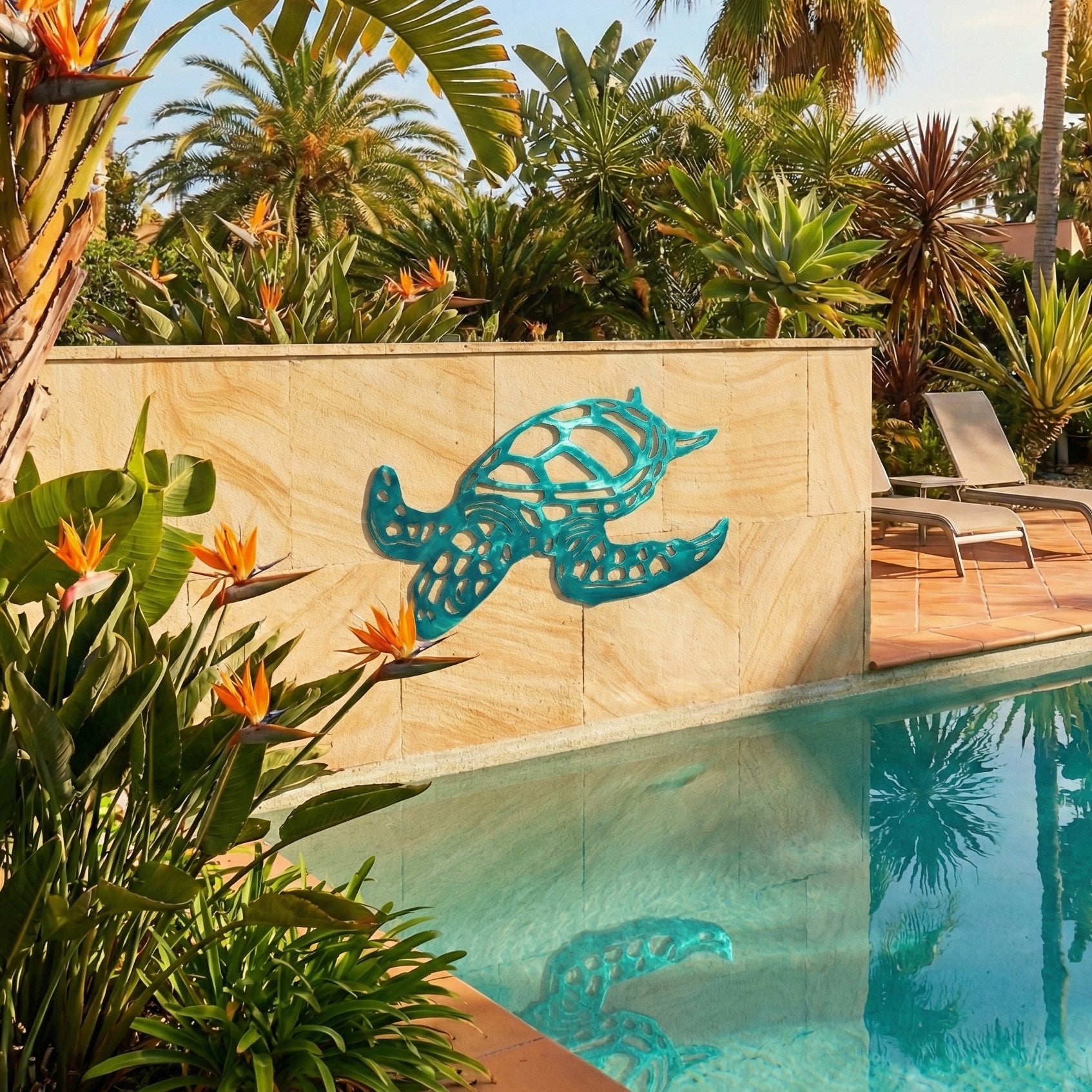 Decorative turtle sculpture on a stone wall by a pool with tropical plants.