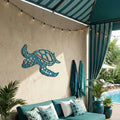 Outdoor patio with teal sofa, decorative turtle wall art, and striped awning.