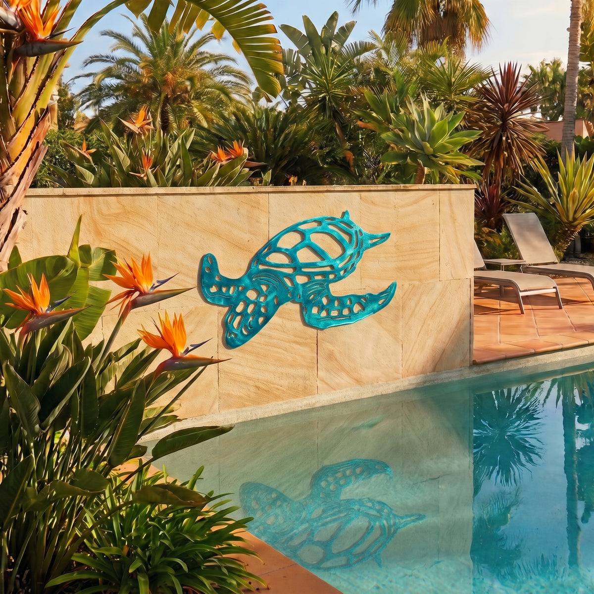 A turquoise metal turtle wall art piece mounted on a beige stone wall beside a swimming pool, surrounded by tropical plants and palm trees.