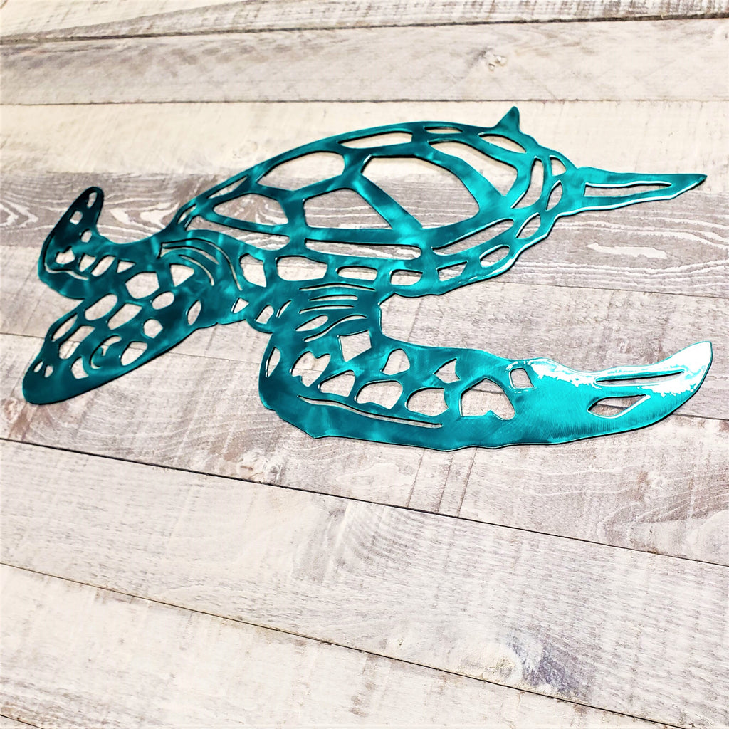 Metal turtle sculpture on a wooden surface