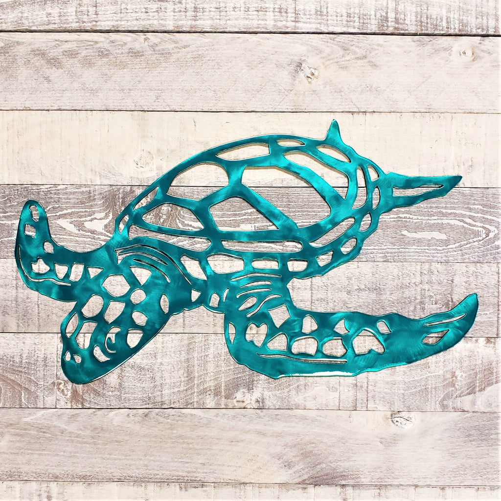 Metal turtle sculpture on a wooden background