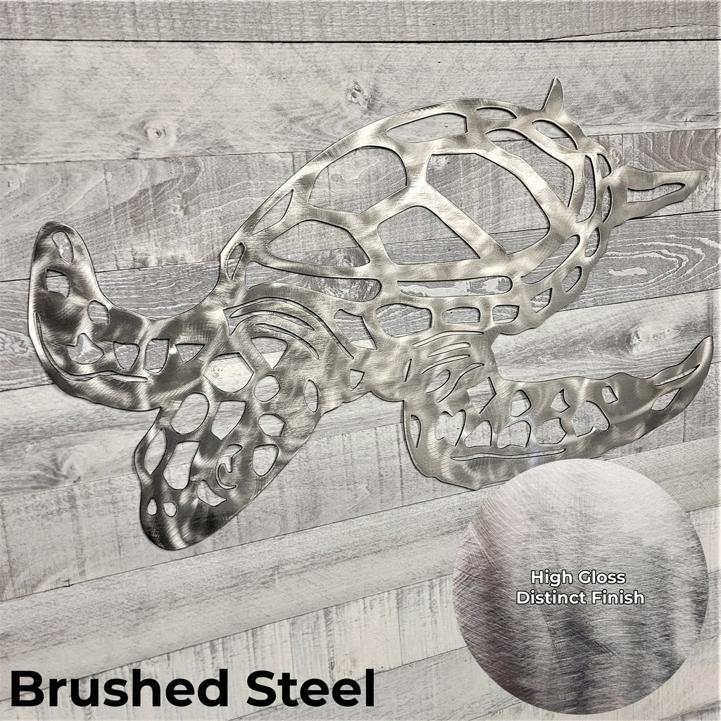 Metal turtle sculpture in brushed steel finish on a wooden background