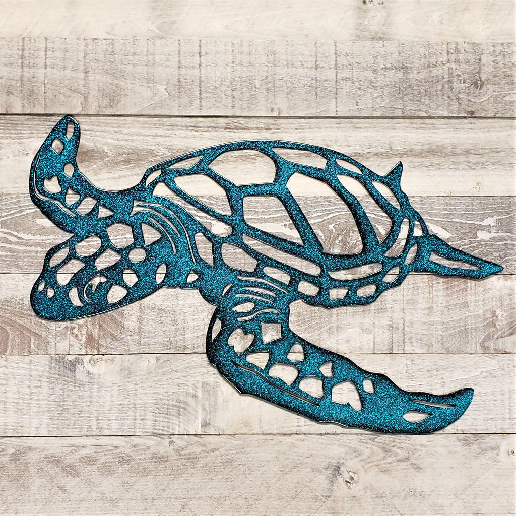 Blue metal turtle sculpture on a wooden surface
