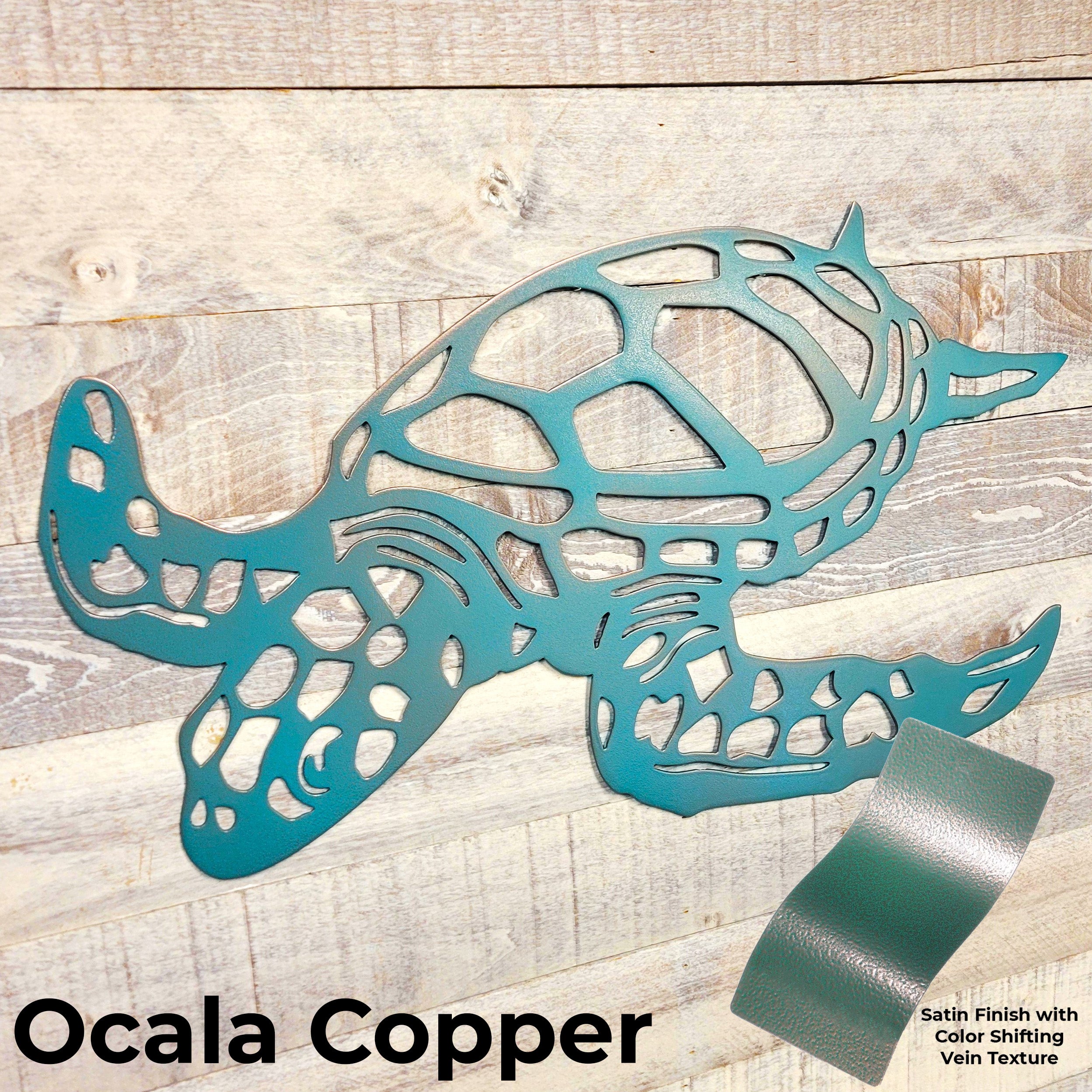 Metal turtle sculpture in Ocala Copper color on a wooden background